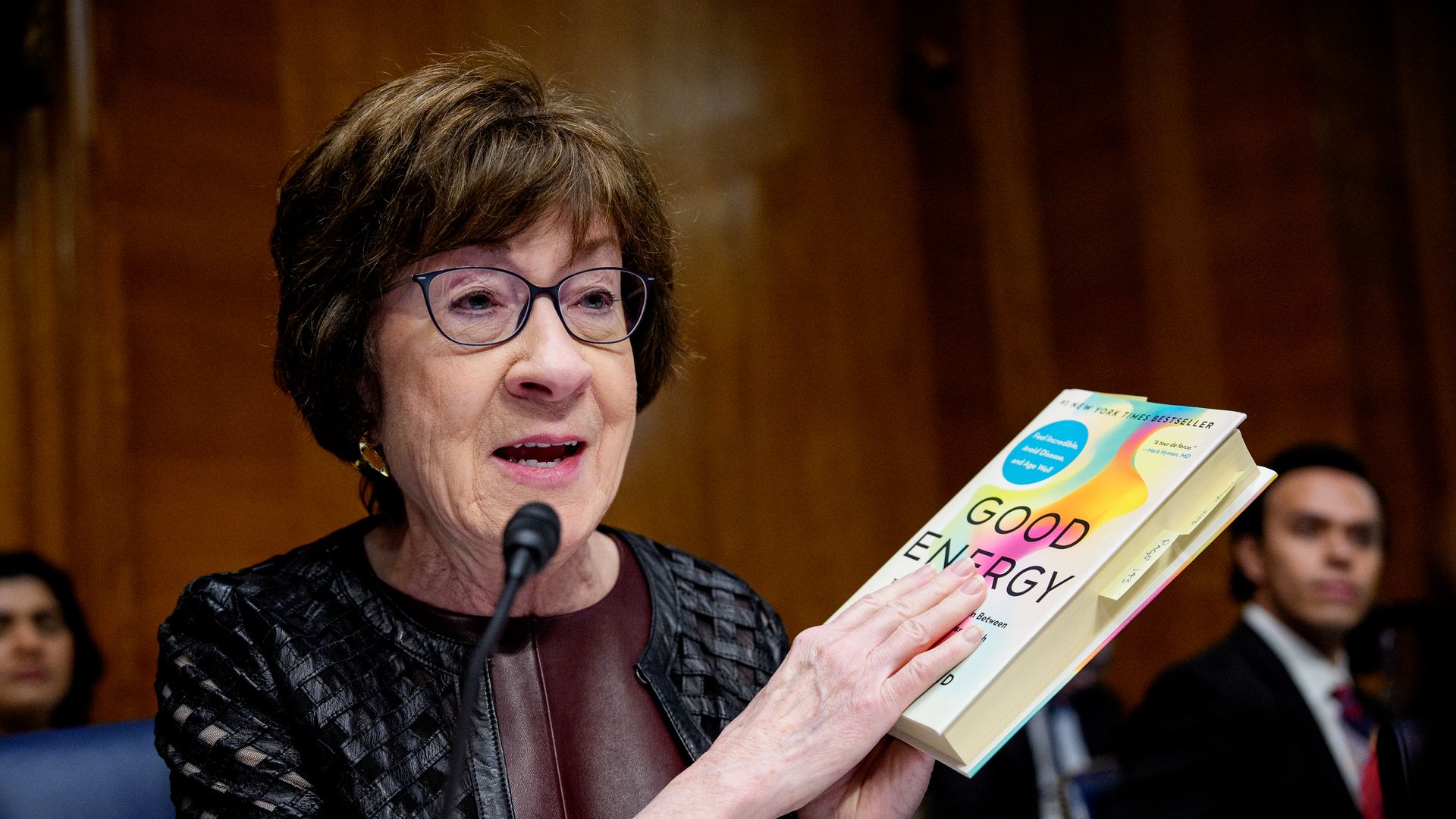 Sen. Susan Collins (R-ME) holds up a book as she speaks during a nomination hearing for Dr. Casey Means, for the medical director in the Regular Corps of the Public Health Service and U.S. surgeon general during a Senate Health, Education, Labor and Pensions Committee 
