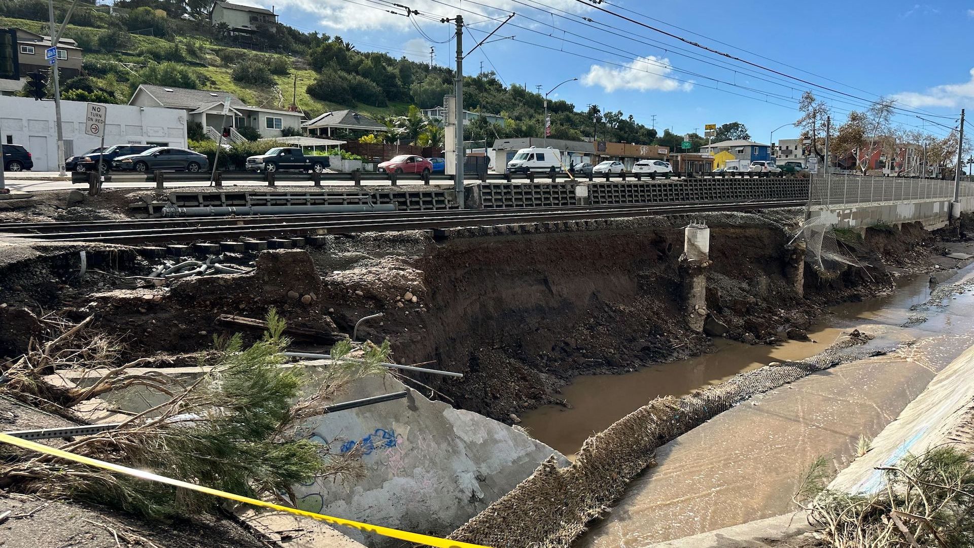 Crumbling roadside trolley tracks damaged by flash flooding.