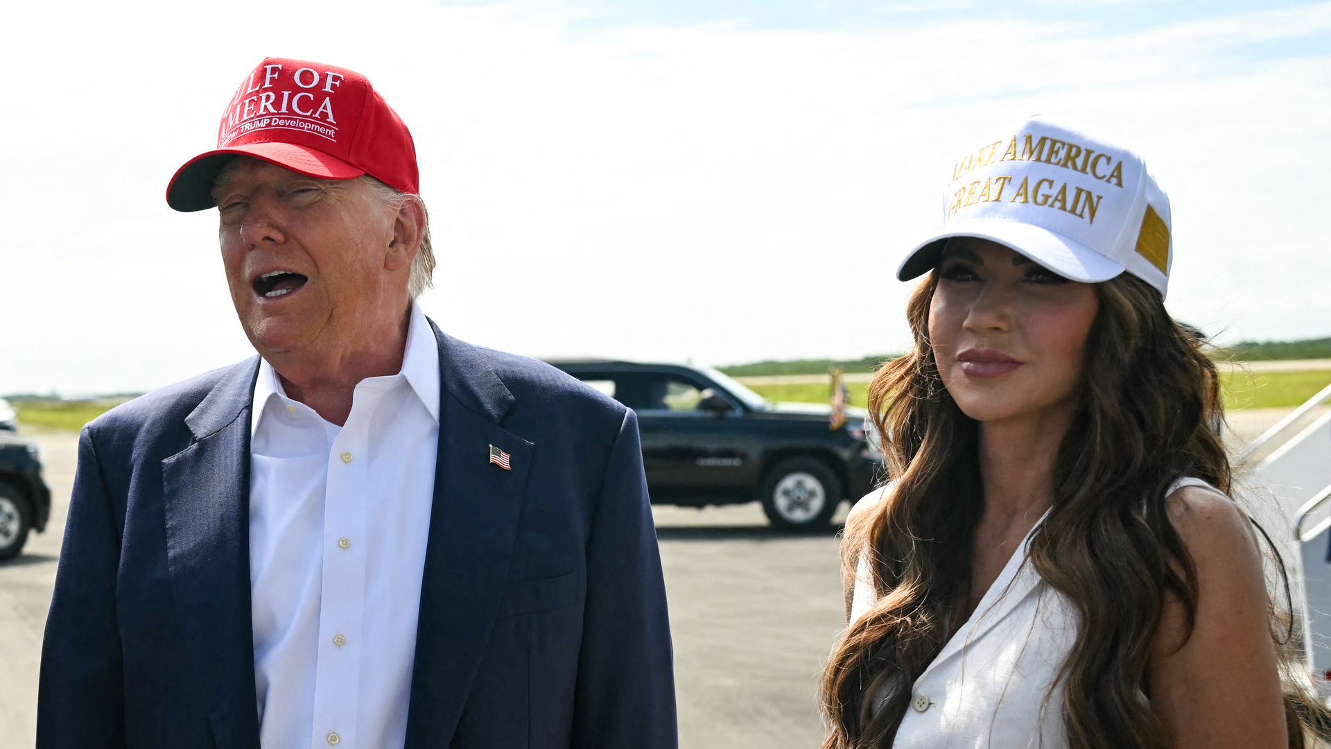 Donald Trump (C), alongside Secretary of Homeland Security Kristi Noem (R) and Florida Governor Ron DeSantis (L), speaks to reporters after arriving at Dade-Collier Training and Transition Airport in Ochopee, Florida, on July 1, 2025.