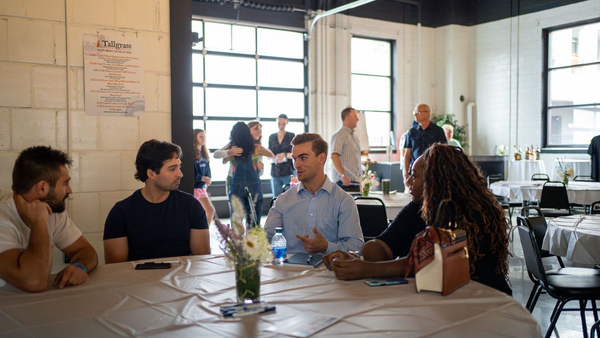 People conversing at a Lyceum event in Des Moines.