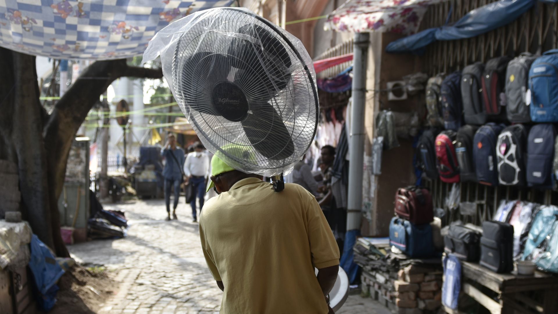 Man walks with fan in Kolkata during a heat wave in April 2022. 