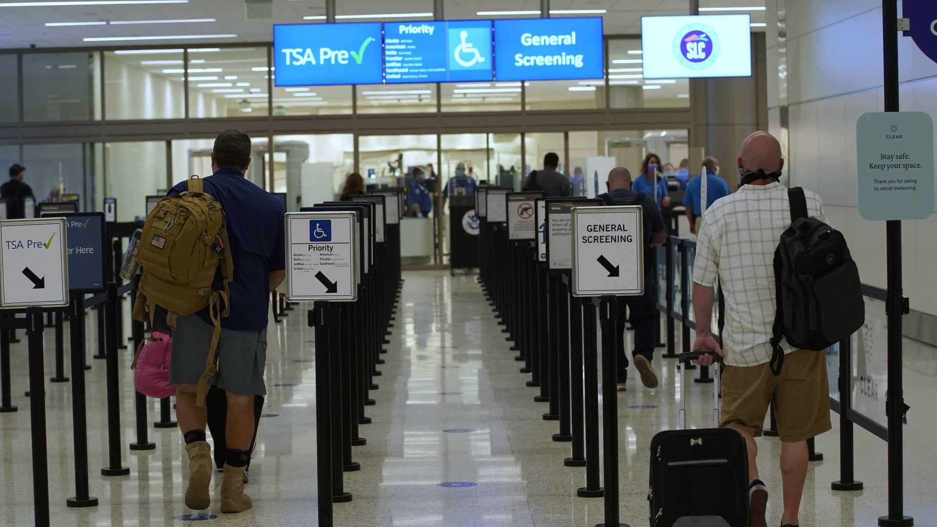 Passengers waiting at an airport security line.