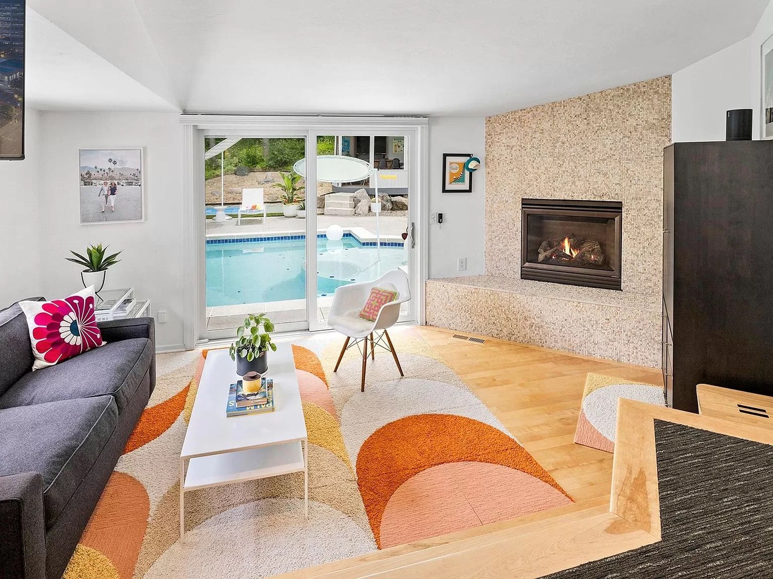 A sitting room with windows overlooking the pool.