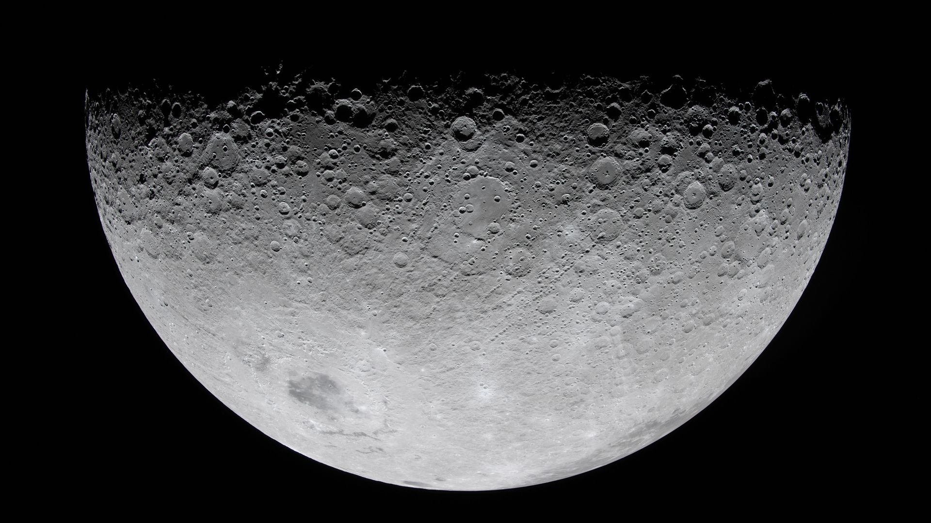 A close-up photo of the Moon shows its cratered surface, half visible and half hidden by shadow. 