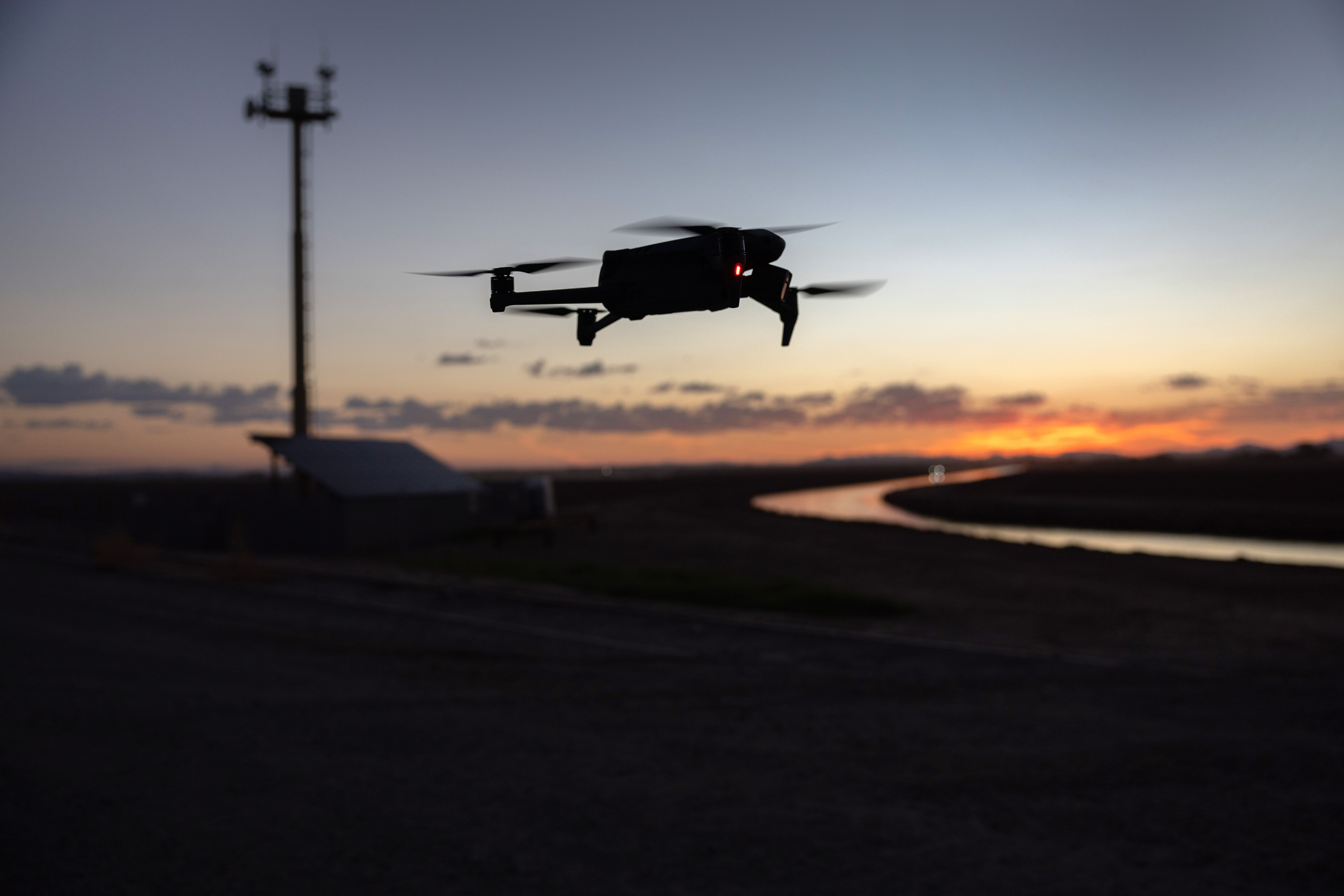 A DJI Mavic 3 drone flies past a U.S. government surveillance tower near the U.S.-Mexico border on September 27, 2022 in Yuma, Arizona.