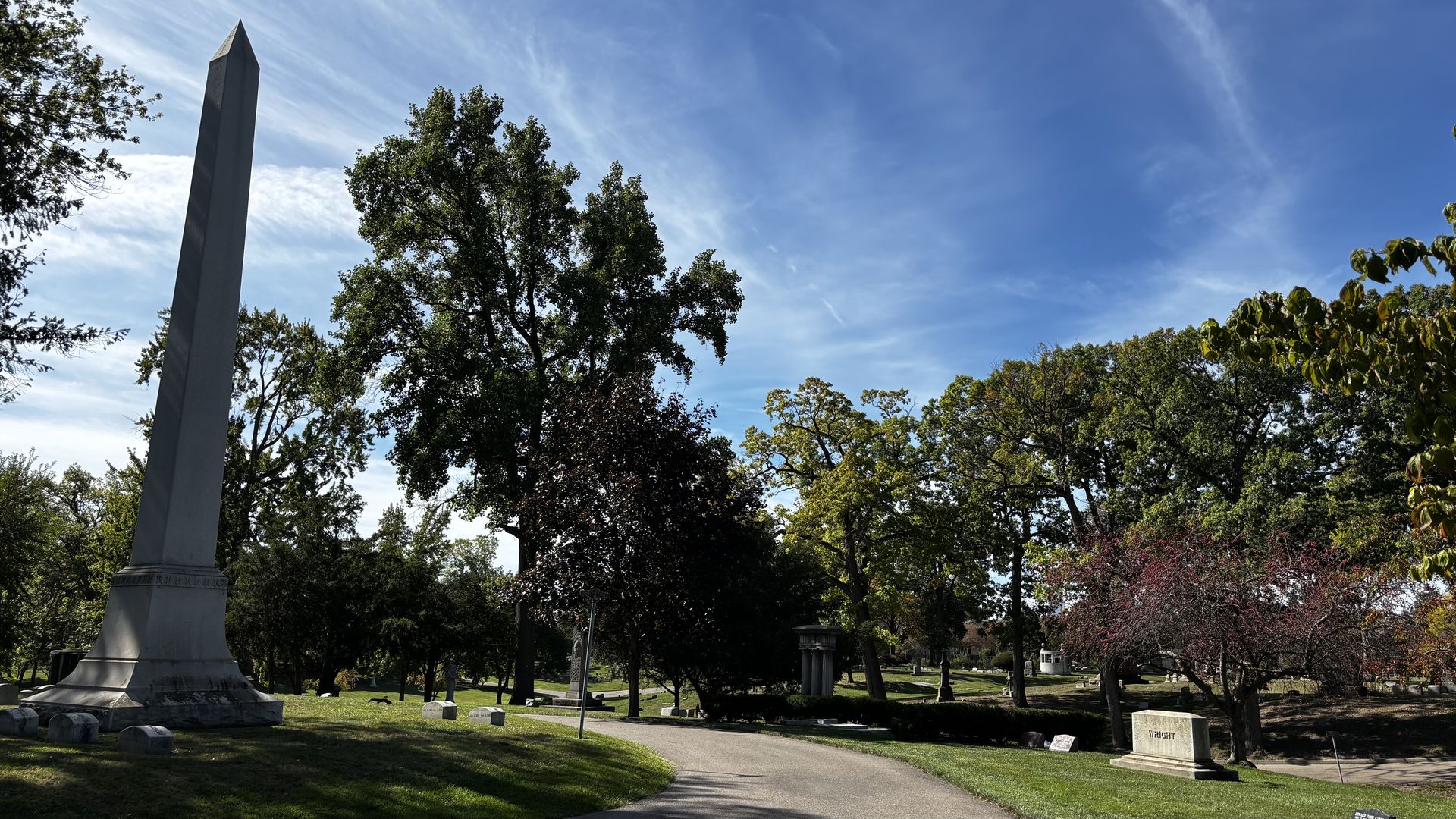 A tall obelisk and trails at Elmwood Cemetery.