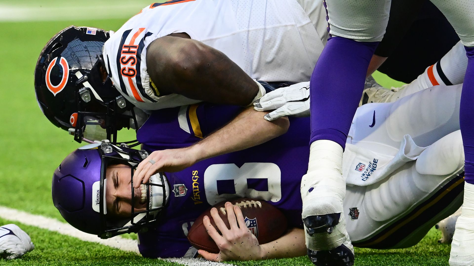 Photo of a football player tackling another football player. 