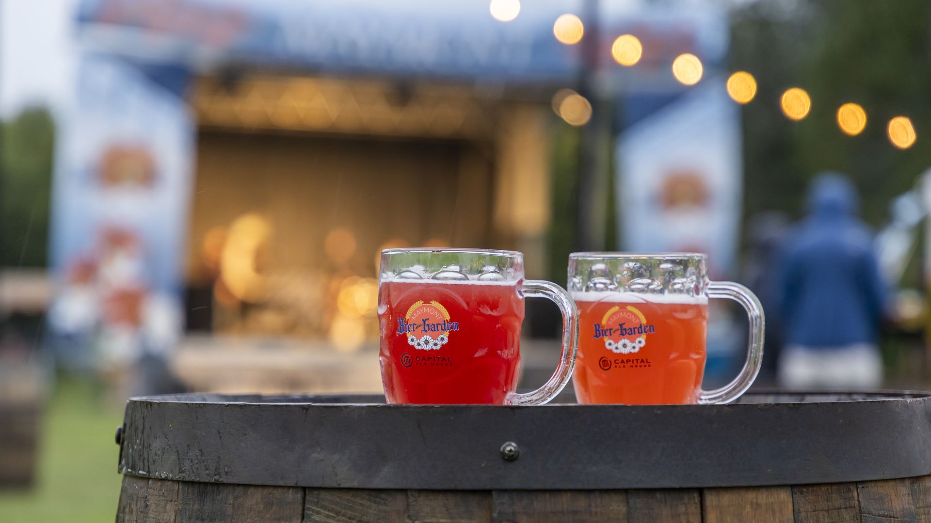 2 beers on a barrel that say BierGarden on the glass 