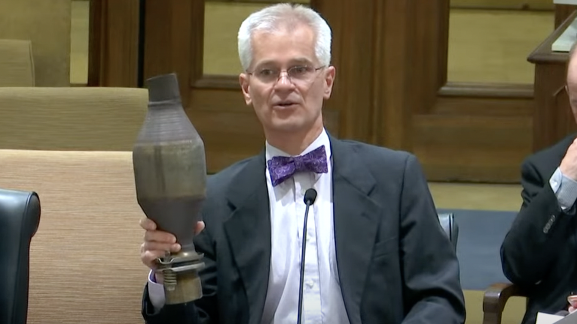John Marty holds a catalytic converter