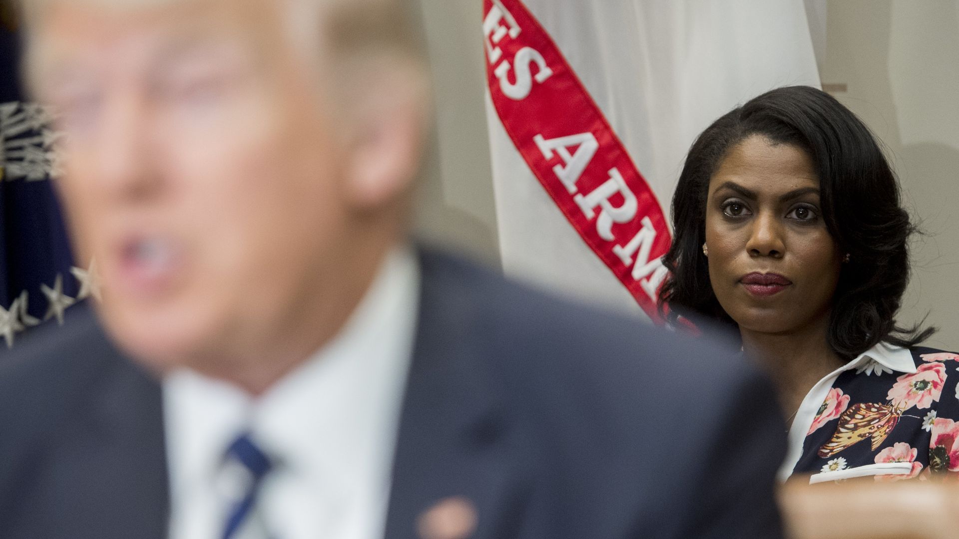 Omarosa sitting behind Trump