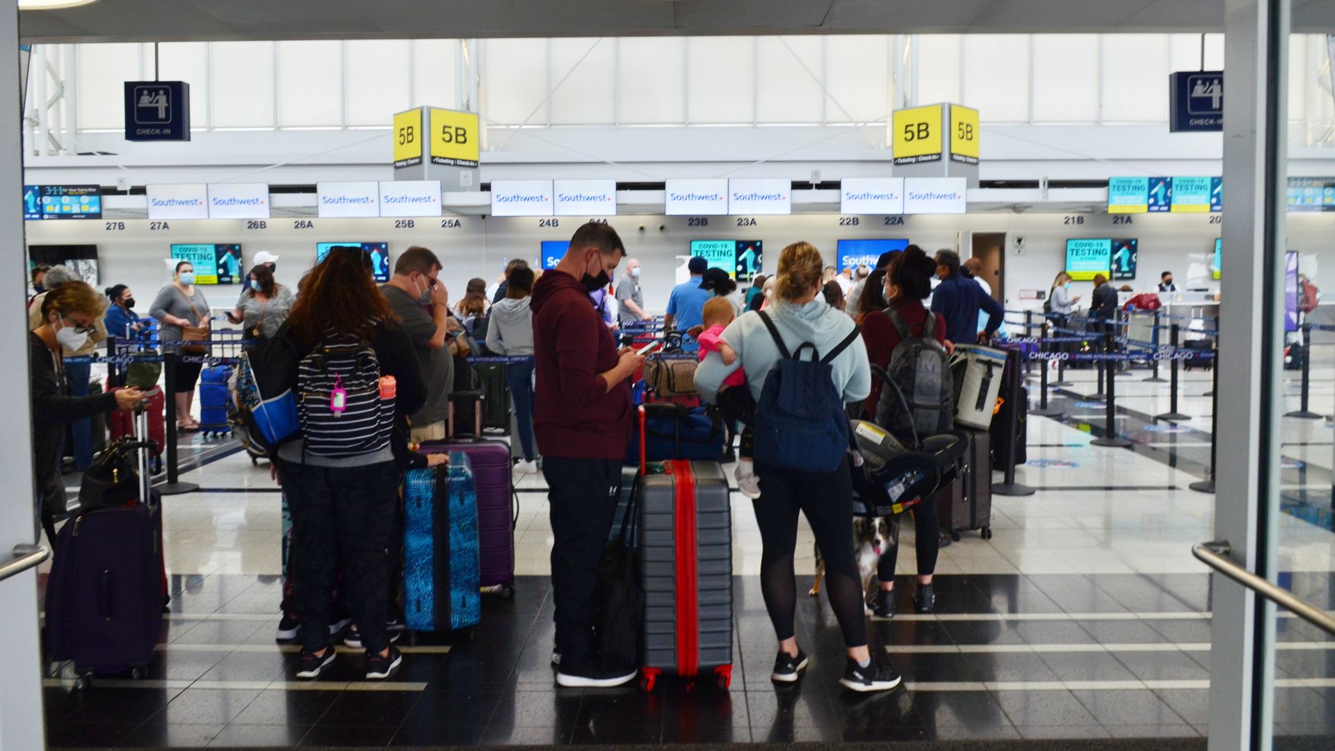 People wait in line to receive information on their flights at Chicago O'Hare International Airport 