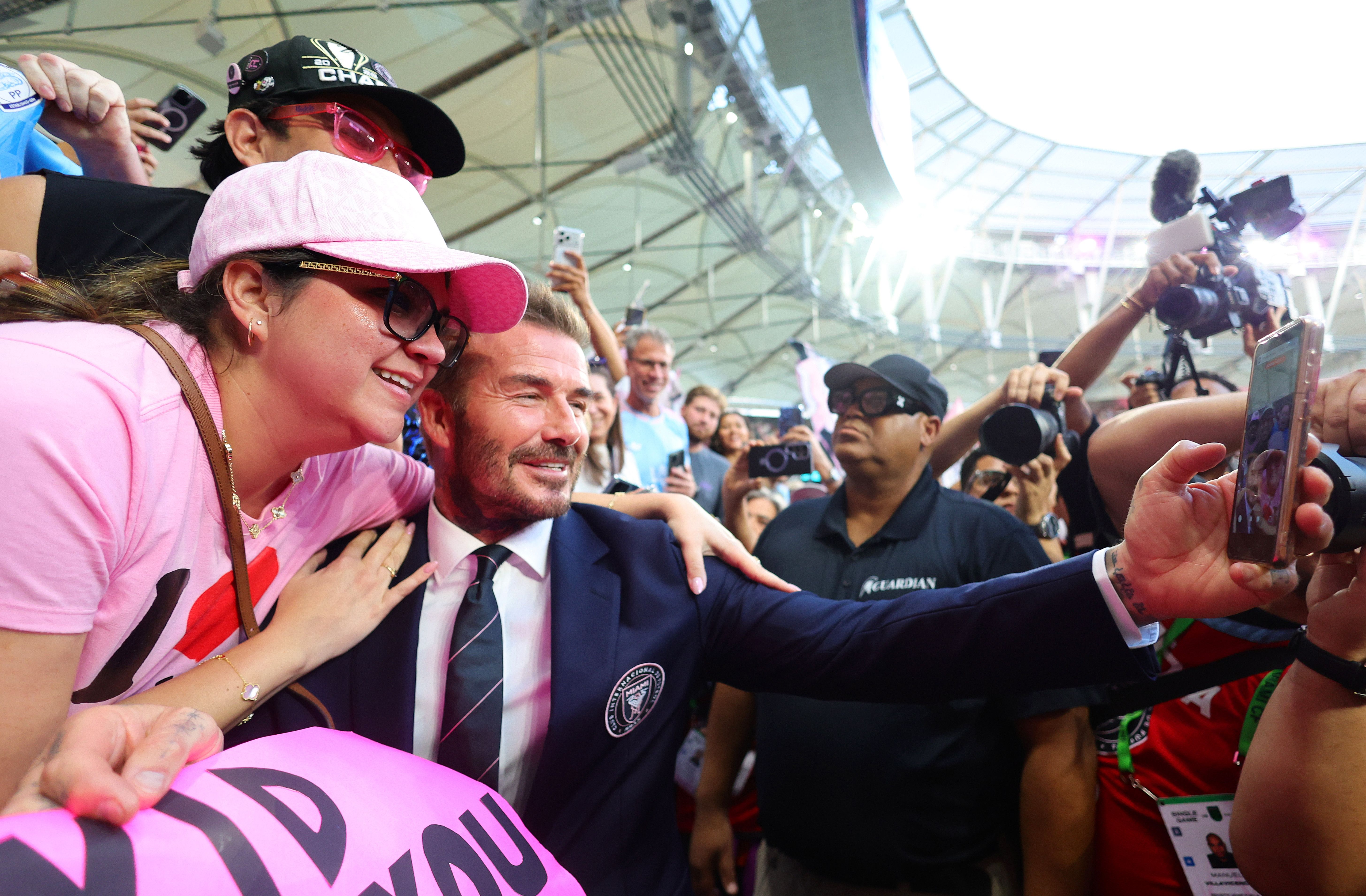 MIAMI, FLORIDA - APRIL 04: Sir David Beckham, Co-owner of Inter Miami CF, takes a photo with a fan prior to the MLS match between Inter Miami CF and Austin FC at Nu Stadium on April 04, 2026 in Miami, Florida. (Photo by Megan Briggs/Getty Images)
