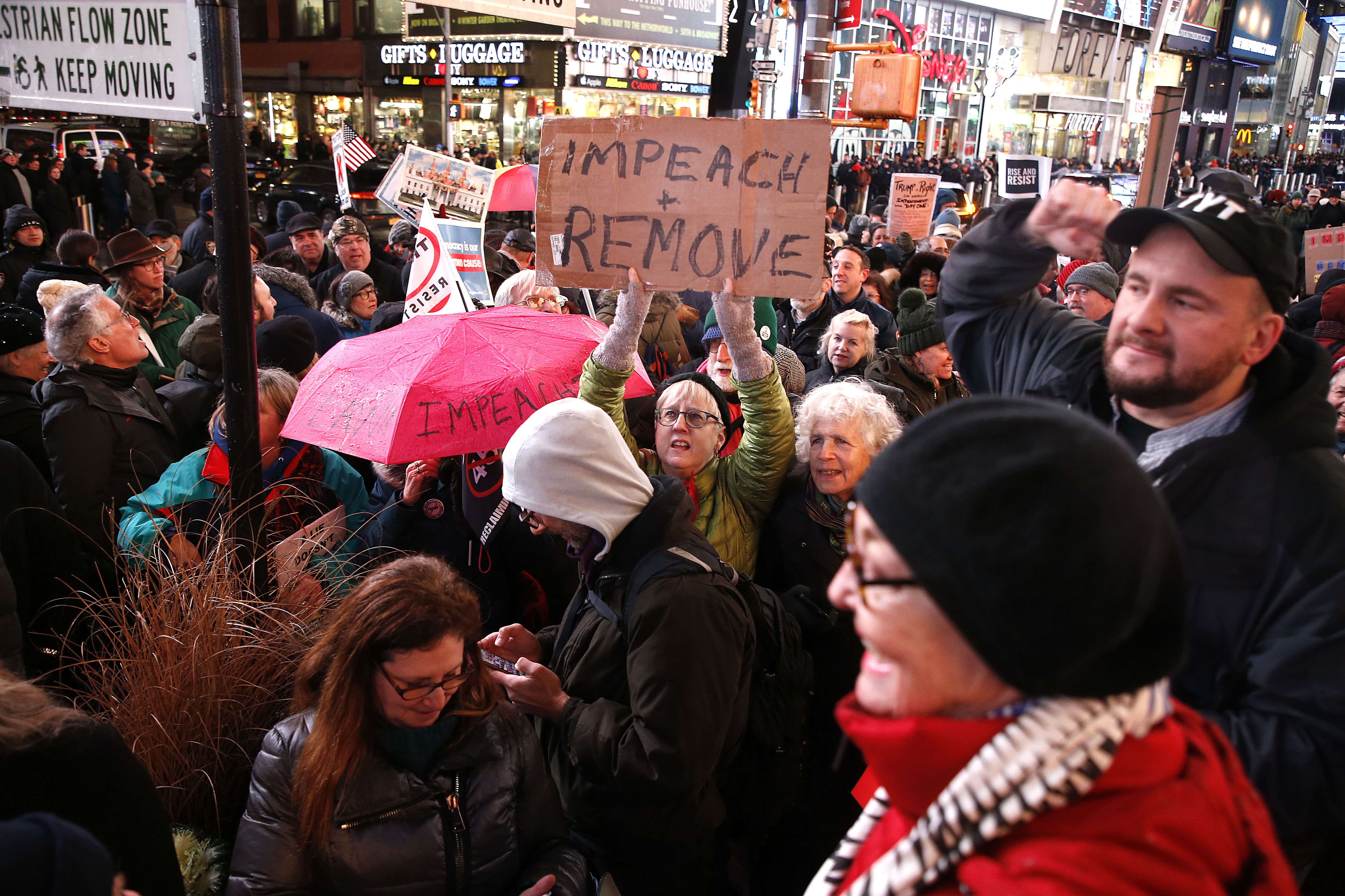 Demonstrators join national impeachment demonstrations to demand an end to Donald Trump's presidency named "Nobody Is Above The Law" Rally - NYC at Times Square on December 17