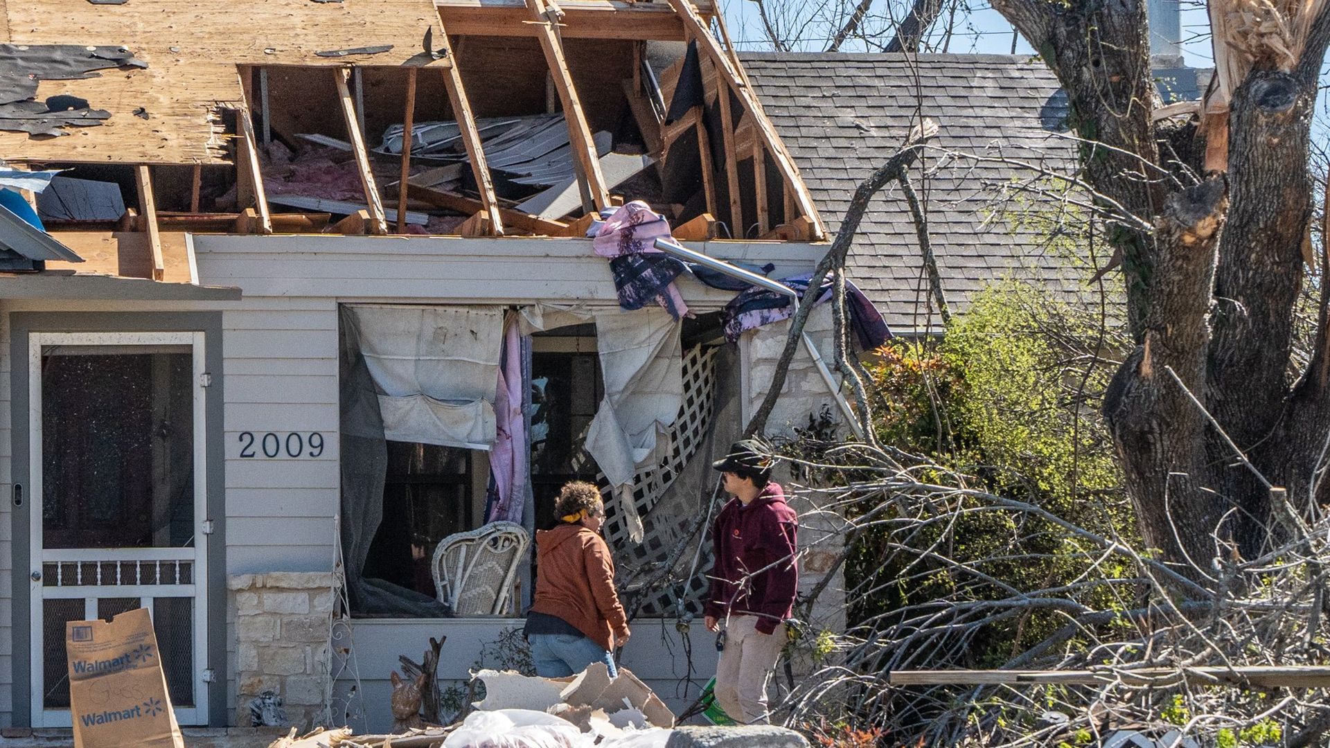 People look at their damaged house after tornados in Round Rock, Texas, the United States on March 22, 2022