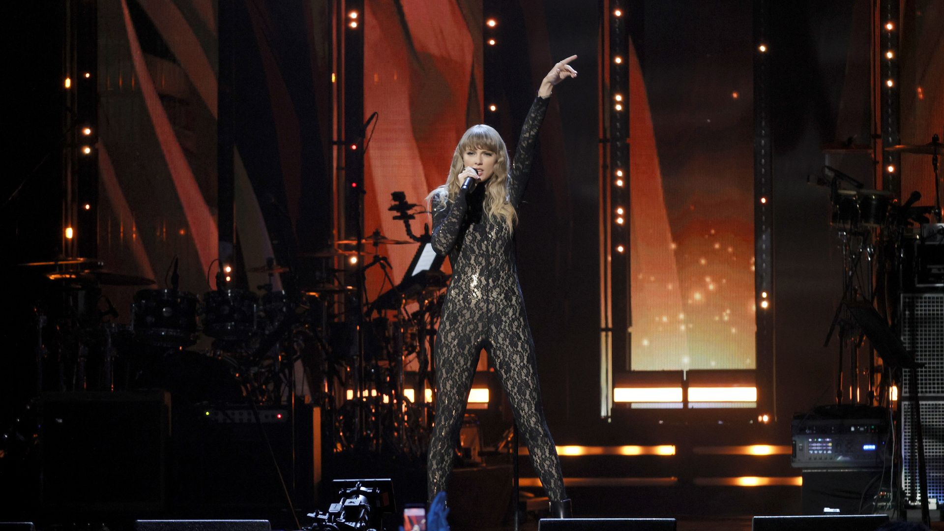 Taylor Swift performs onstage during in a sheer, full body lace cat suit.