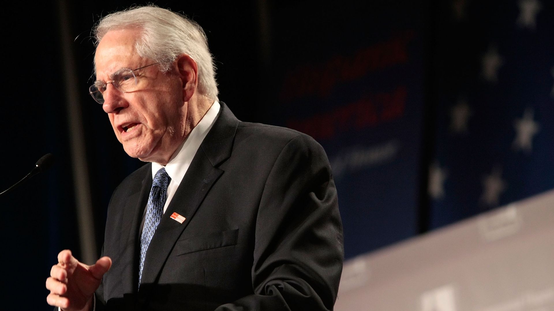 In this image, Mike Gravel speaks from behind a podium.