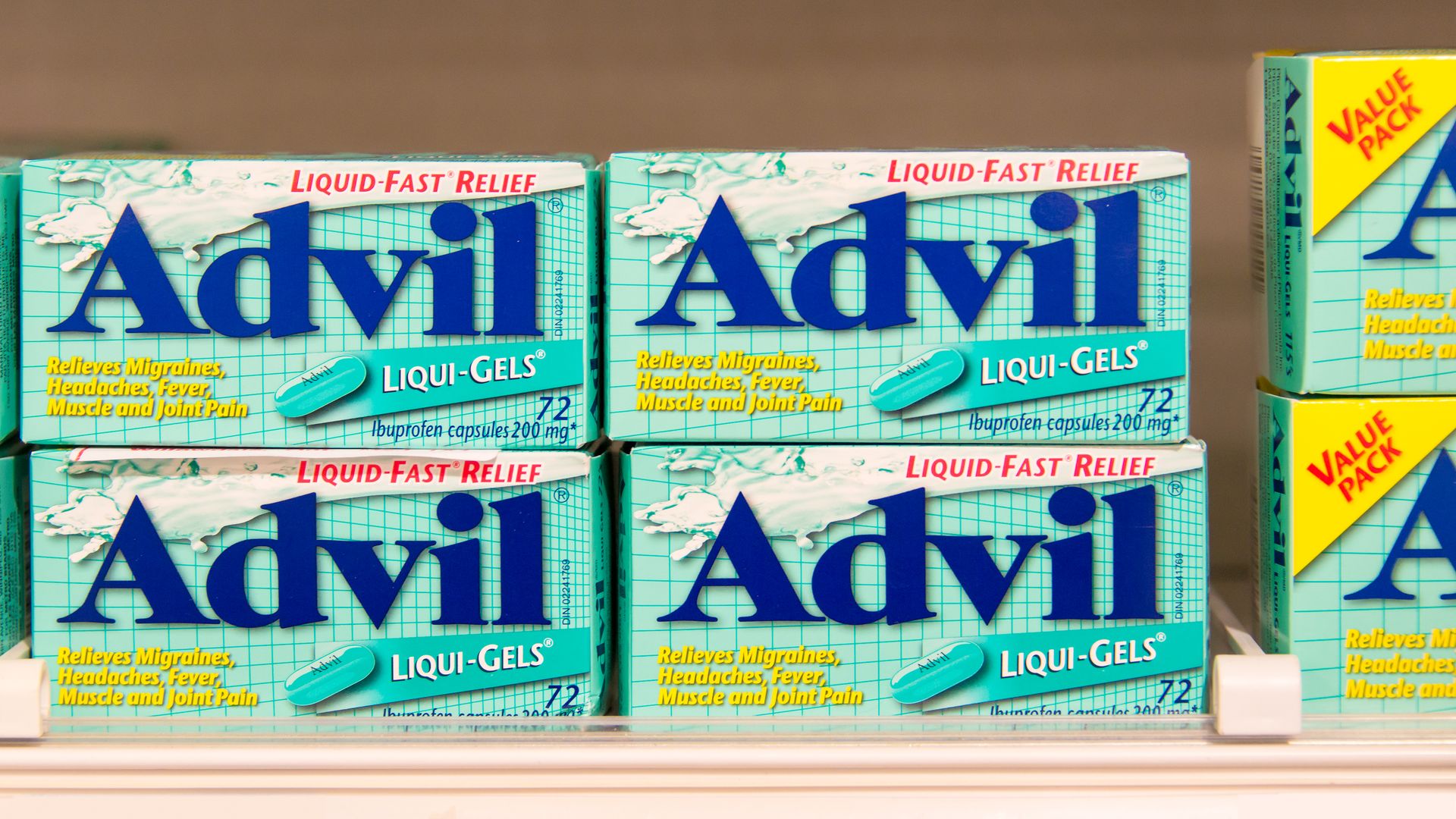 Advil packages sit on a shelf.