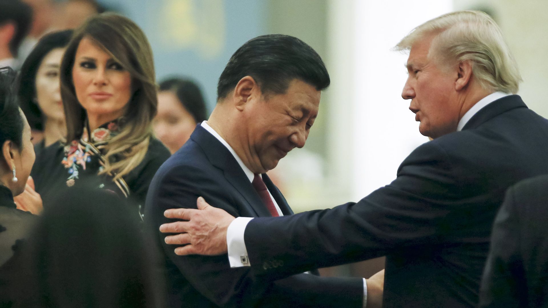 Donald Trump and Xi Jinping shake hands.