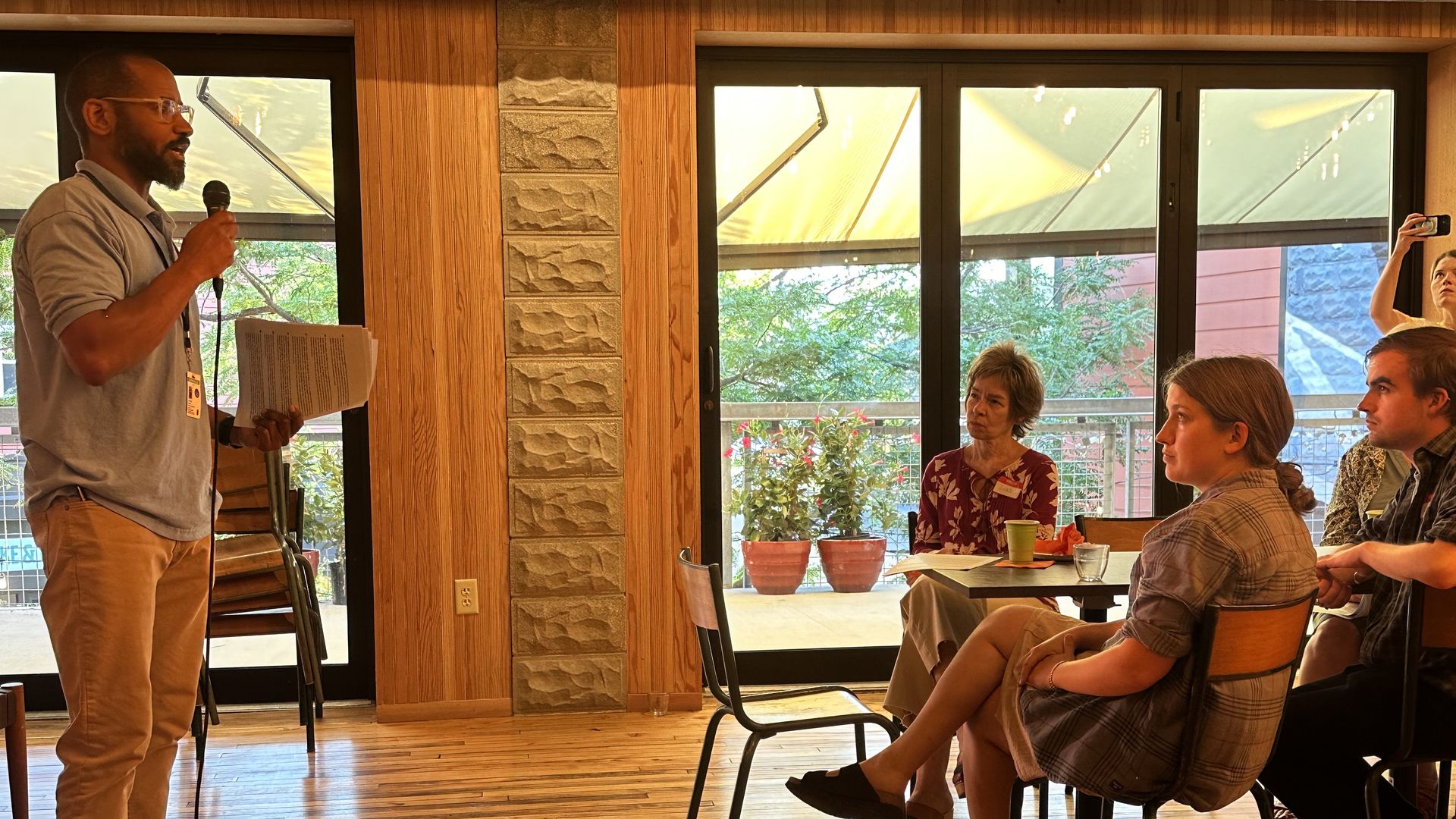Steven Flythe, deputy director of Somerville's department or racial and social justice, addresses the crowd at the Frederick Douglass reading at Bow Market. 
