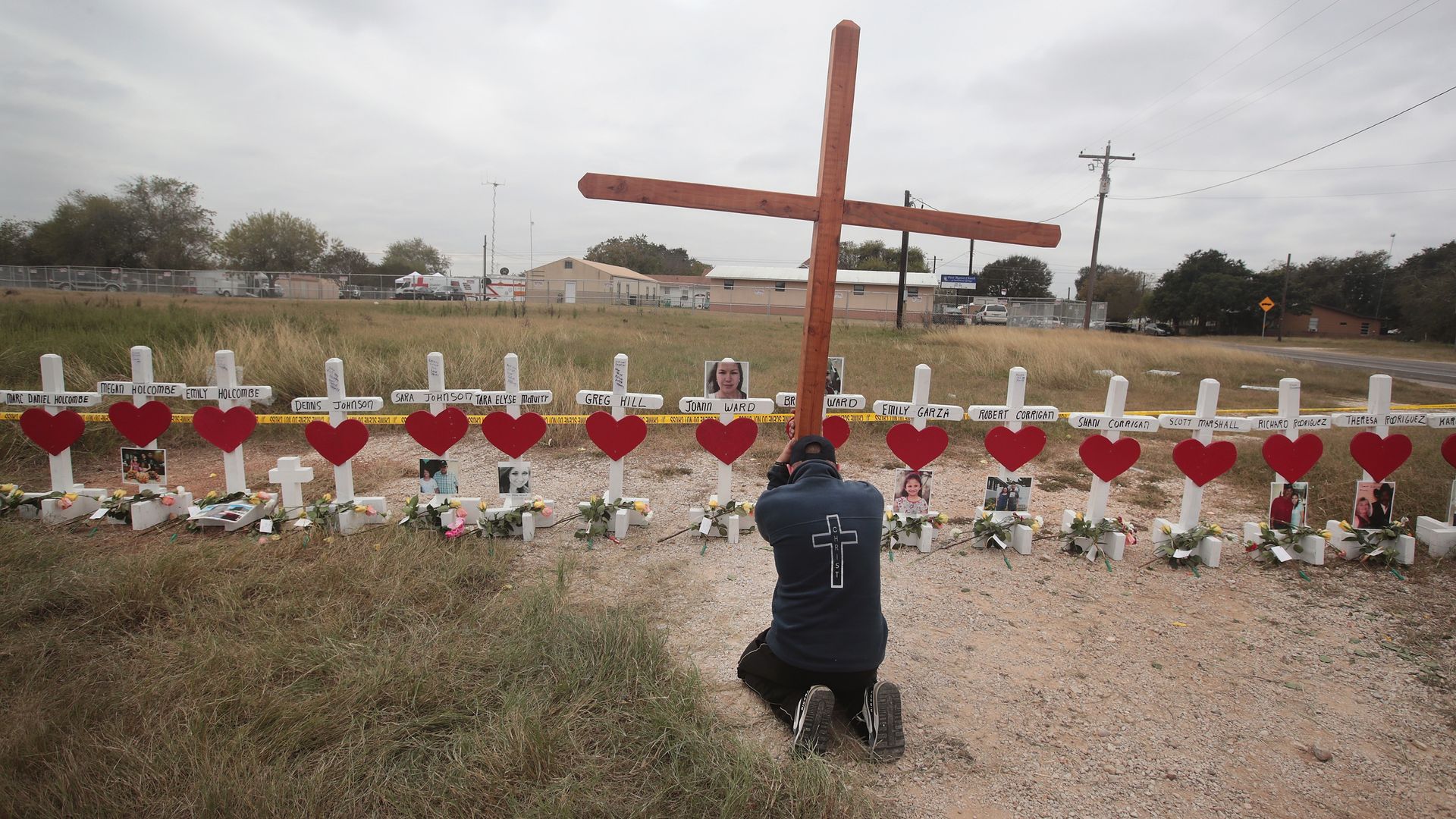 A man prays at a memorial where 26 crosses were placed to honor the 26 victims killed at the First Baptist Church of Sutherland Springs on November 9, 2017 in Sutherland Springs, Texas.