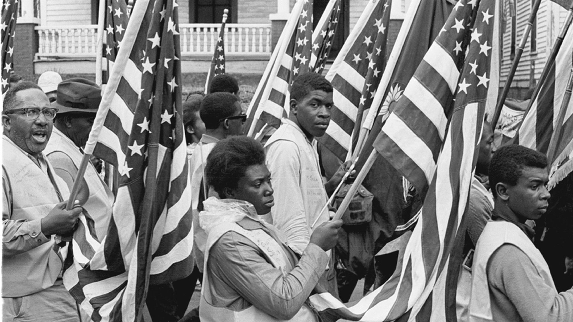 Demonstrators and marchers carry American flags on the Selma to Montgomery march held in support of voter rights, Alabama, late March, 1965.