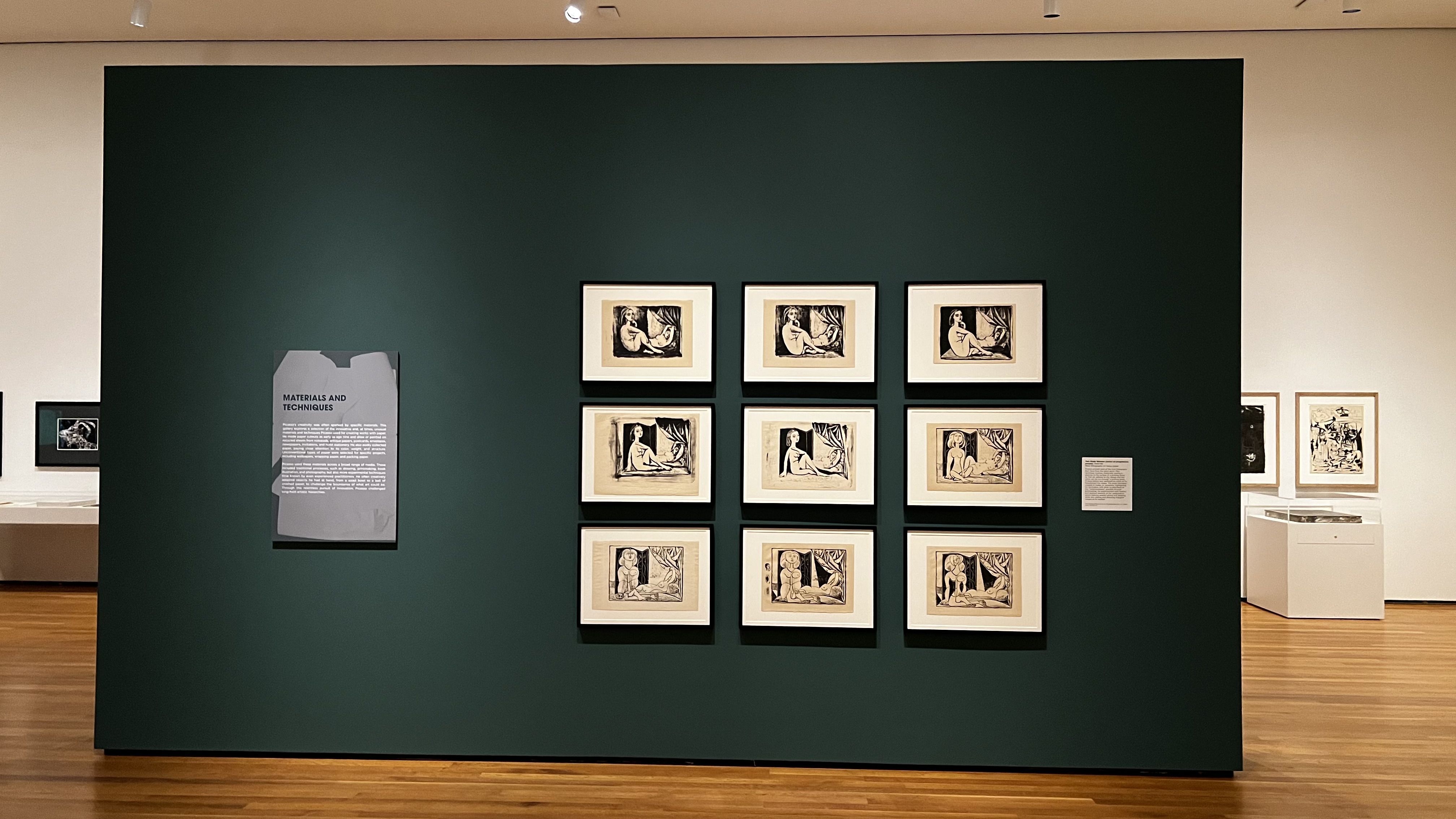 Picasso sketches hang on a wall. 