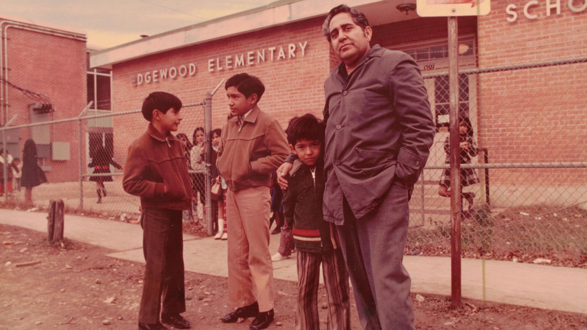 Demetrio Rodriguez outside an Edgewood ISD campus with his sons. 
