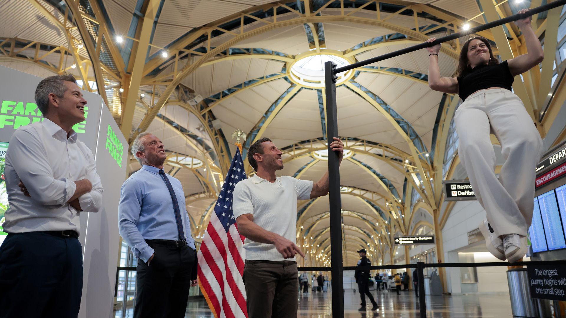 Human Services Secretary Robert F. Kennedy Jr., U.S. Transportation Secretary Sean P. Duffy and influencer Dr. Paul Saladino watch Paloma Duffy do pull-ups after a conference discussing the launch of the "Make Travel Family Friendly Again" campaign at Ronald Reagan Washington National Airport on Dec