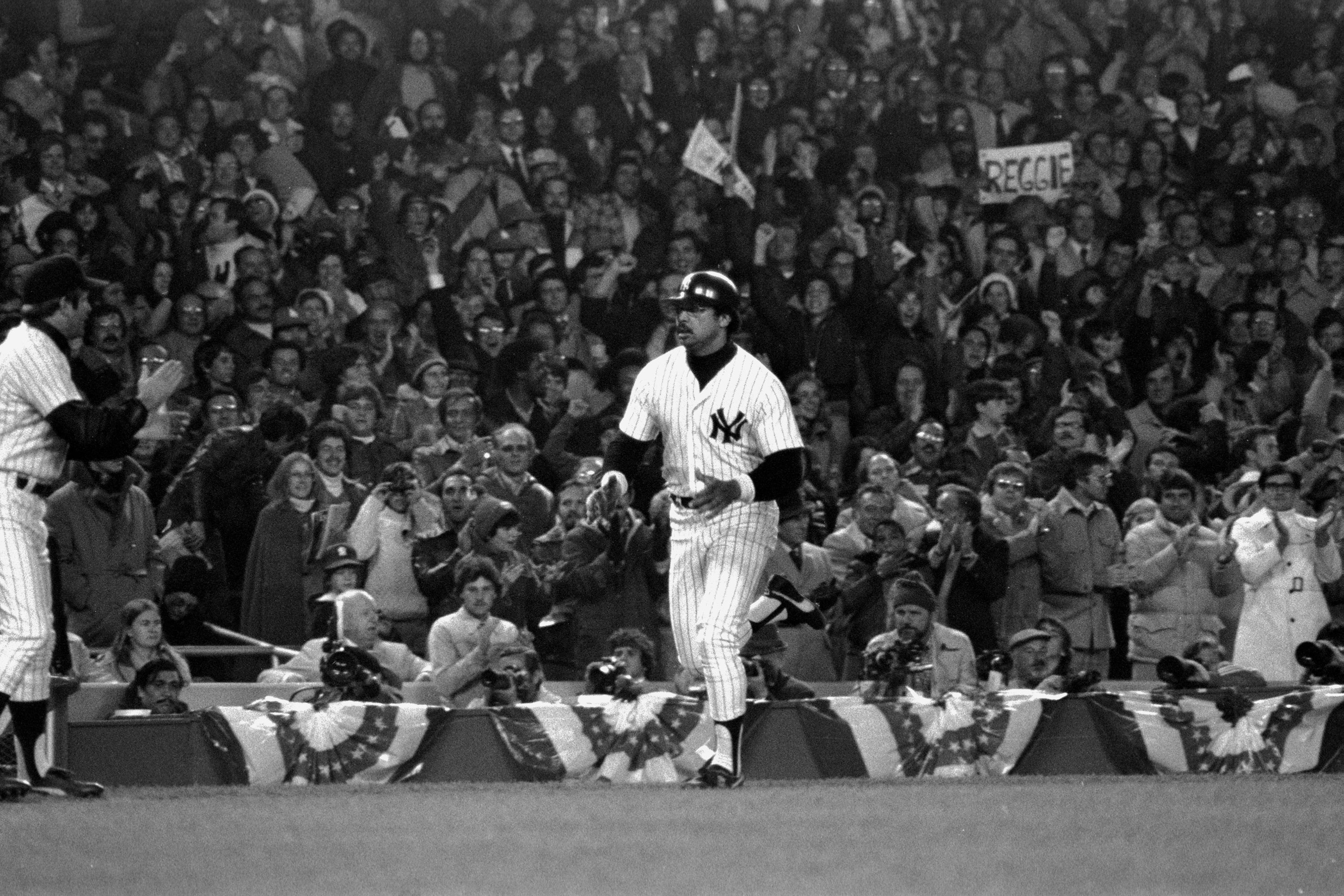 New York Yankees' slugger Reggie Jackson nonchalantly trots toward home plate after his second of three home runs against the Los Angeles Dodgers in Game Six of the 1977 World Series in Yankees Stadium.