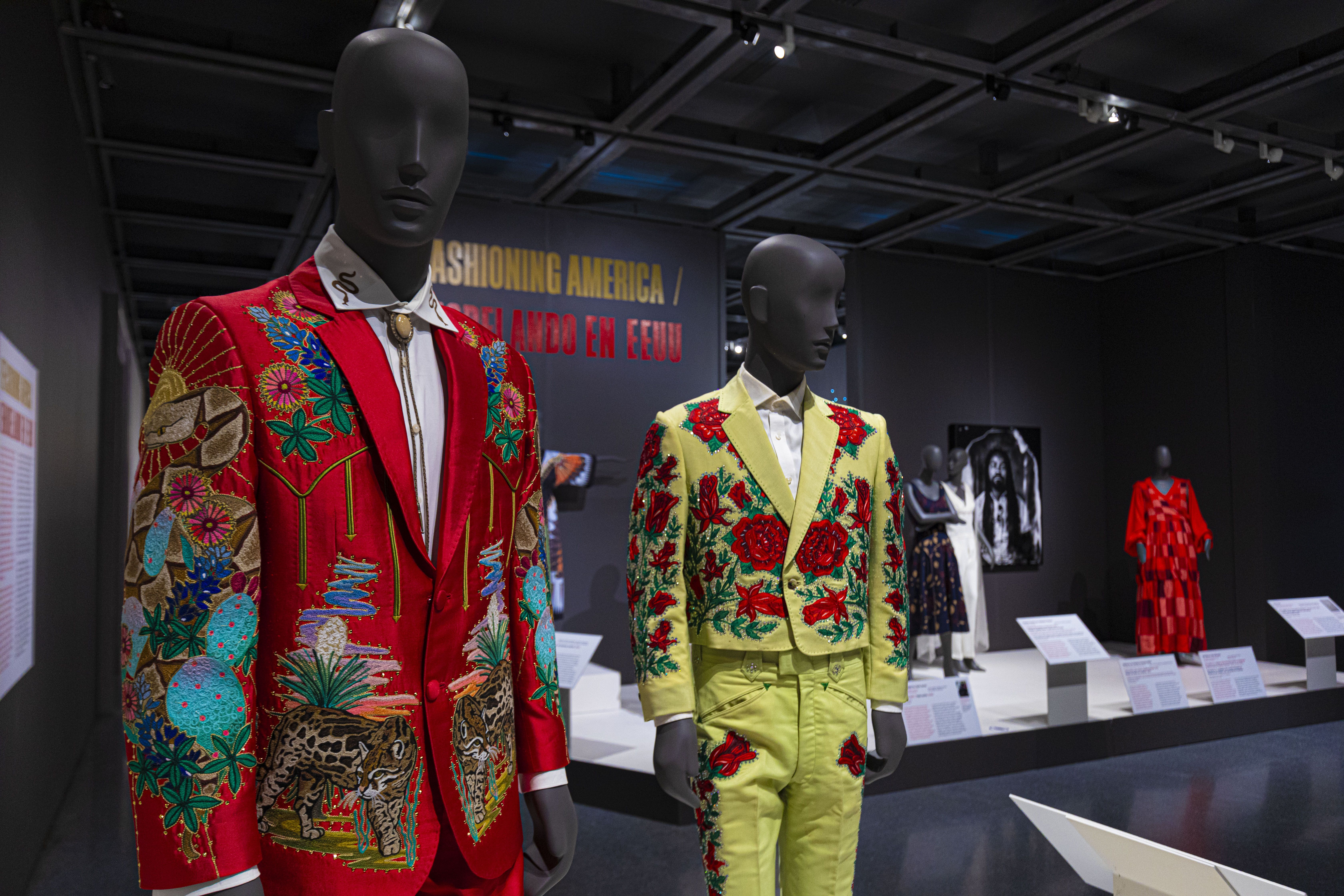 A detail shot of two Nudie-style suits, one in red and one in yellow.