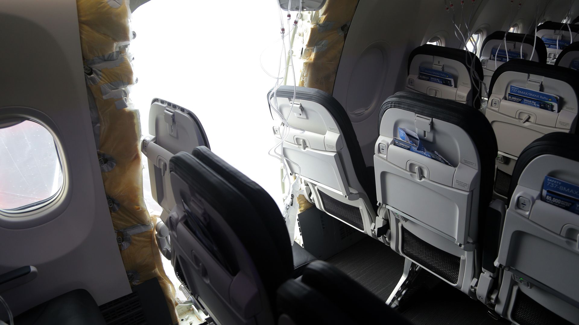 In this National Transportation Safety Board (NTSB) handout, an opening is seen in the fuselage of Alaska Airlines Flight 1282 Boeing 737-9 MAX on January 7, 2024 in Portland, Oregon.