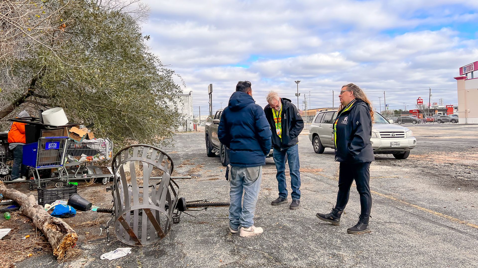 People talking to an unhoused man