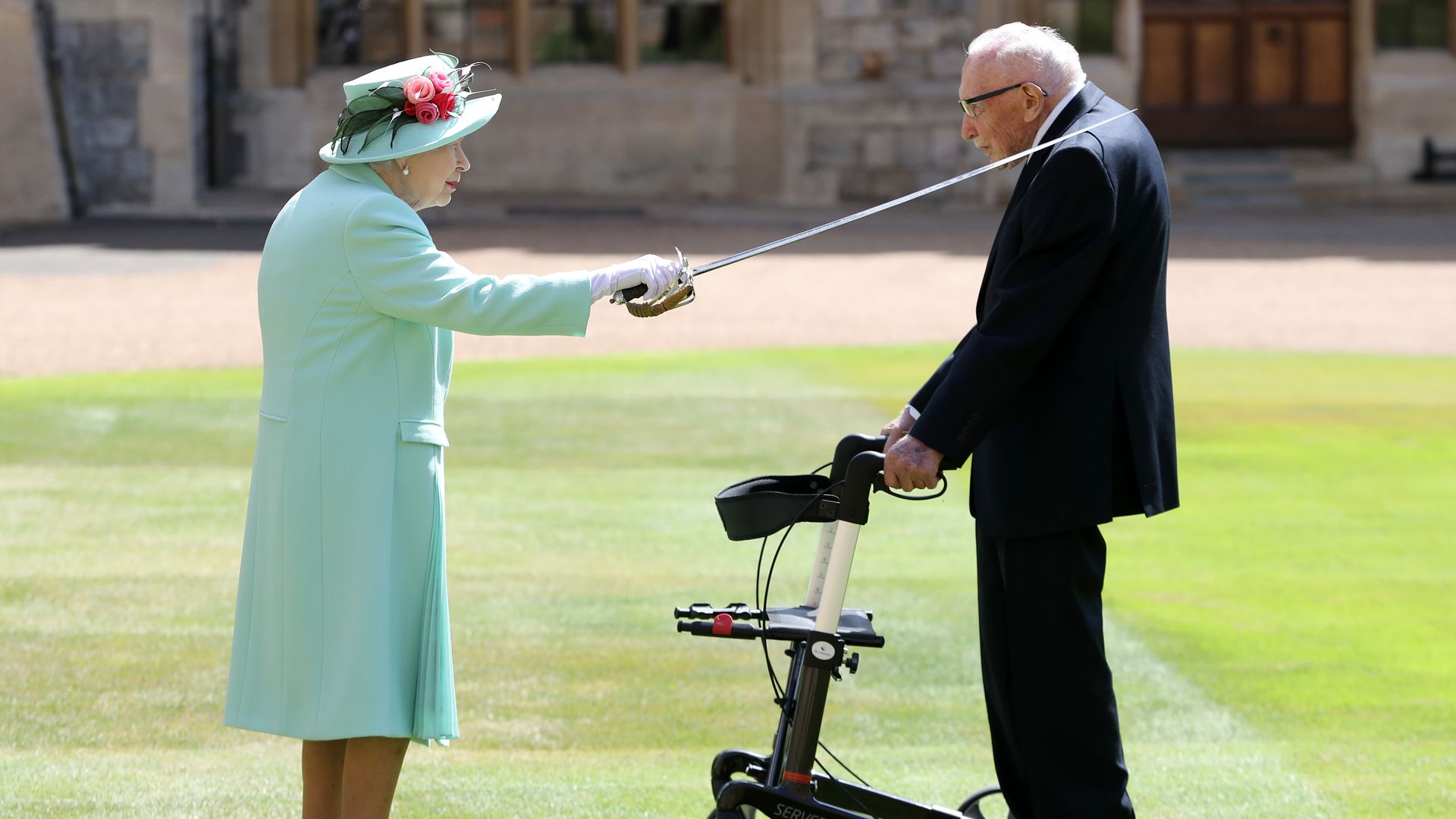 Queen Elizabeth II knights Captain Sir Thomas Moore. Photo: Chris Jackson/Getty Images