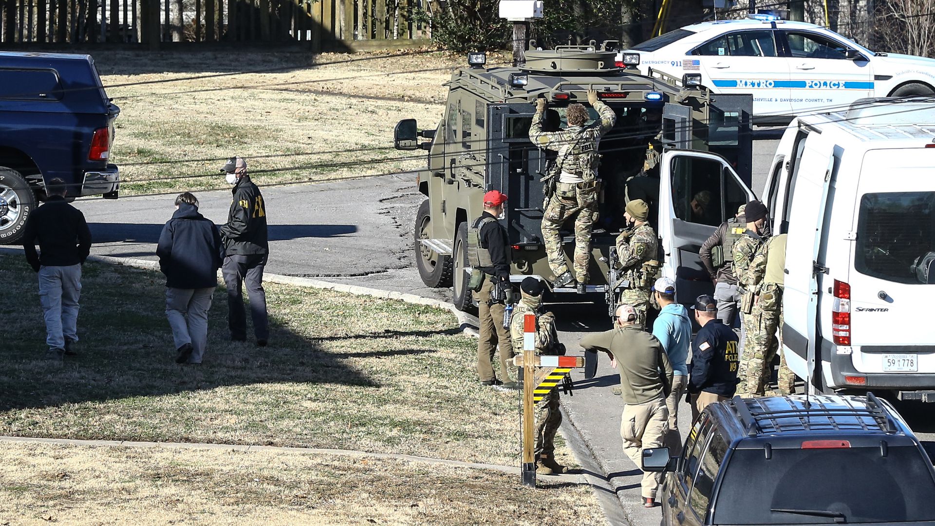 Law enforcement officers investigate the house belonging a person of interest in the Nashville bombing