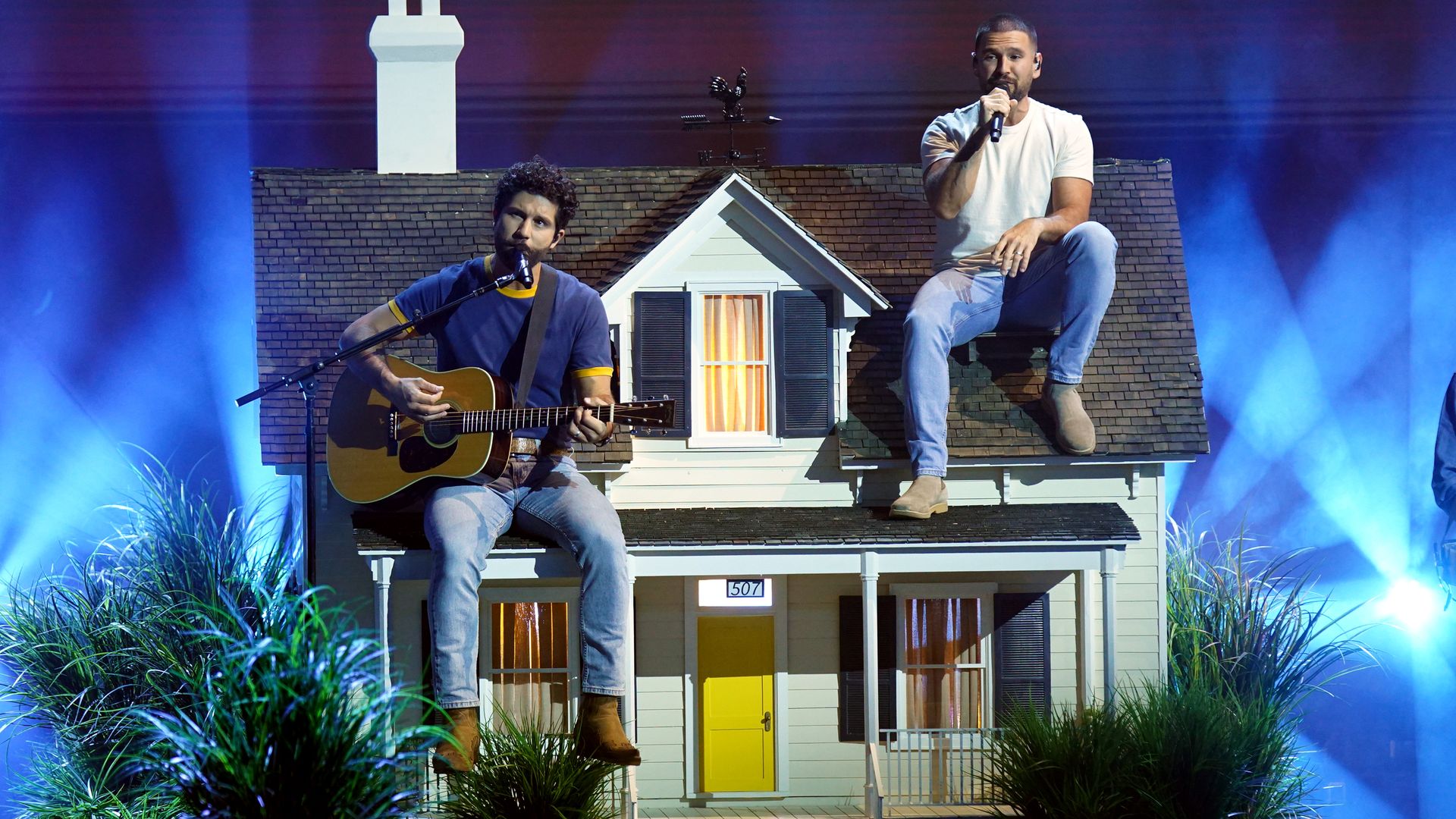 Dan + Shay perform on a stage built into the shape of a house.