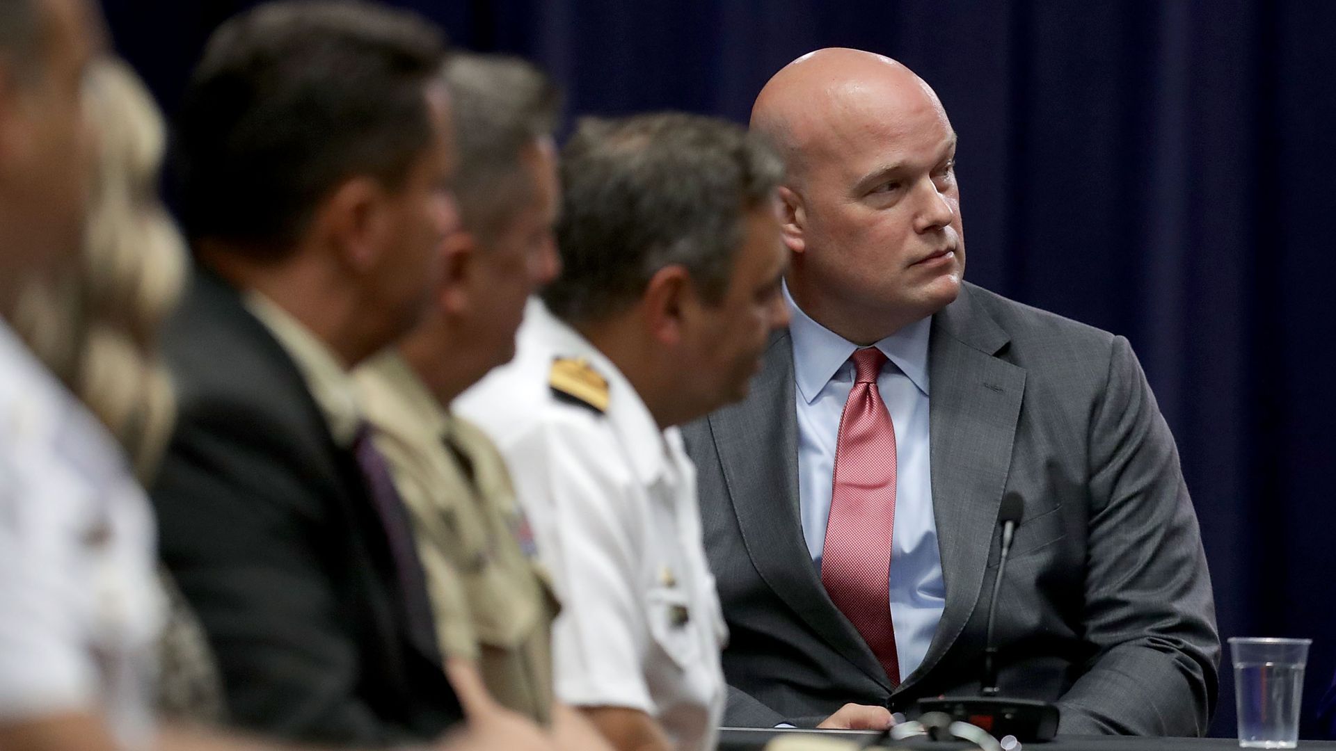 Matt Whitaker sits at a meeting