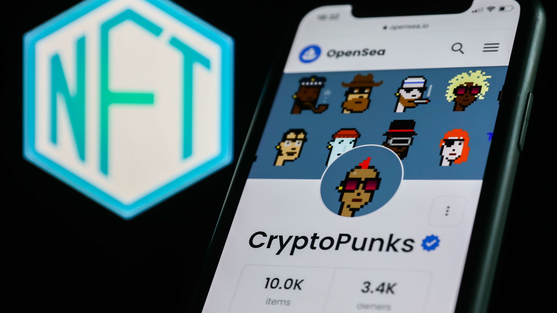 CryptoPunks collection in OpenSea displayed on a phone screen and NFT logo displayed on a screen are seen in this illustration photo taken in Krakow, Poland on April 19, 2022. 