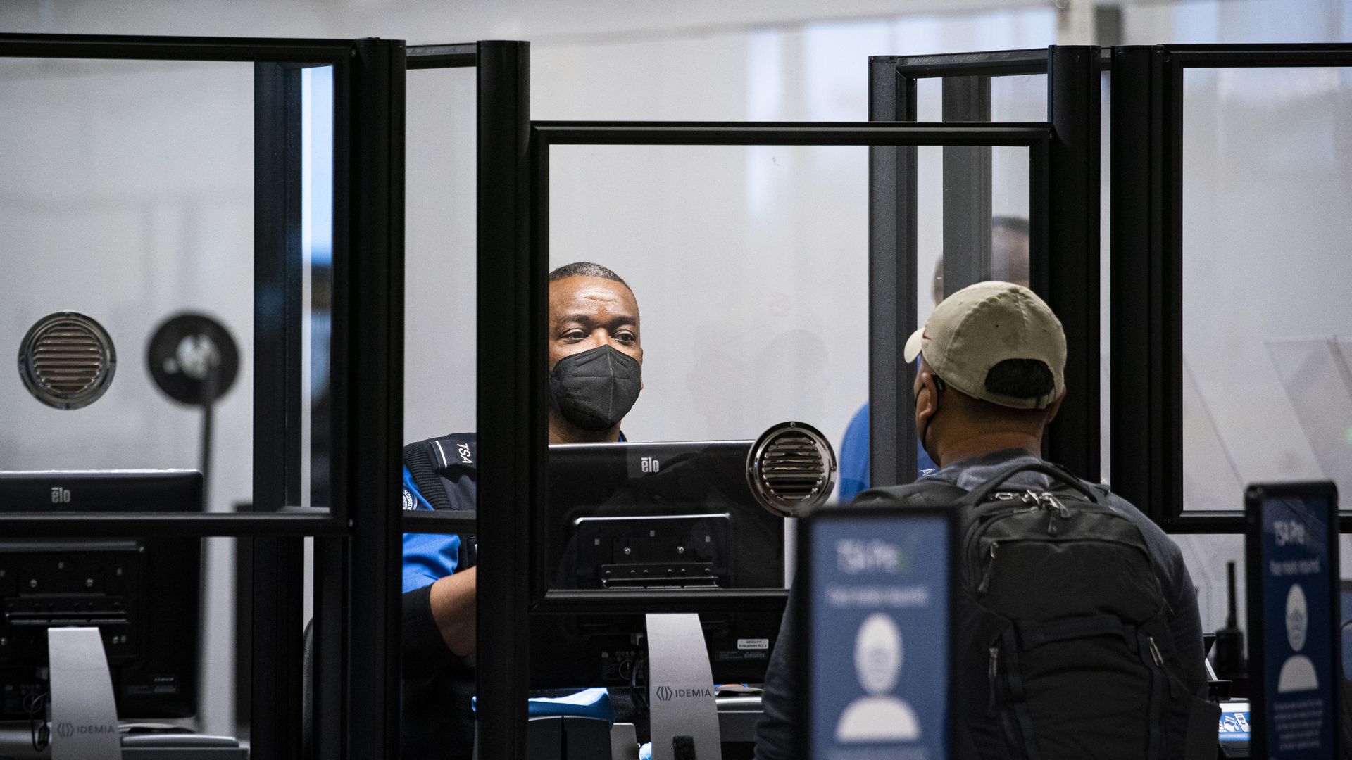 A Transportation Security Administration (TSA) agent screens a traveler at a checkpoint in terminal 2 at Raleigh-Durham International Airport (RDU) in Morrisville, North Carolina, U.S., on Thursday, Jan. 20, 2022. For the third time in less than two months, the U.S. aviation system on Tuesday faced 