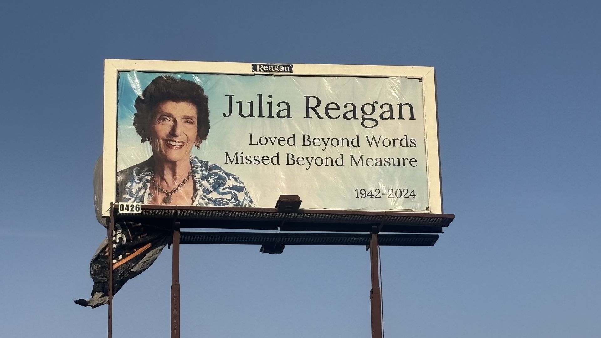Julia Reagan billboard that says "Loved beyond words missing beyond measure."