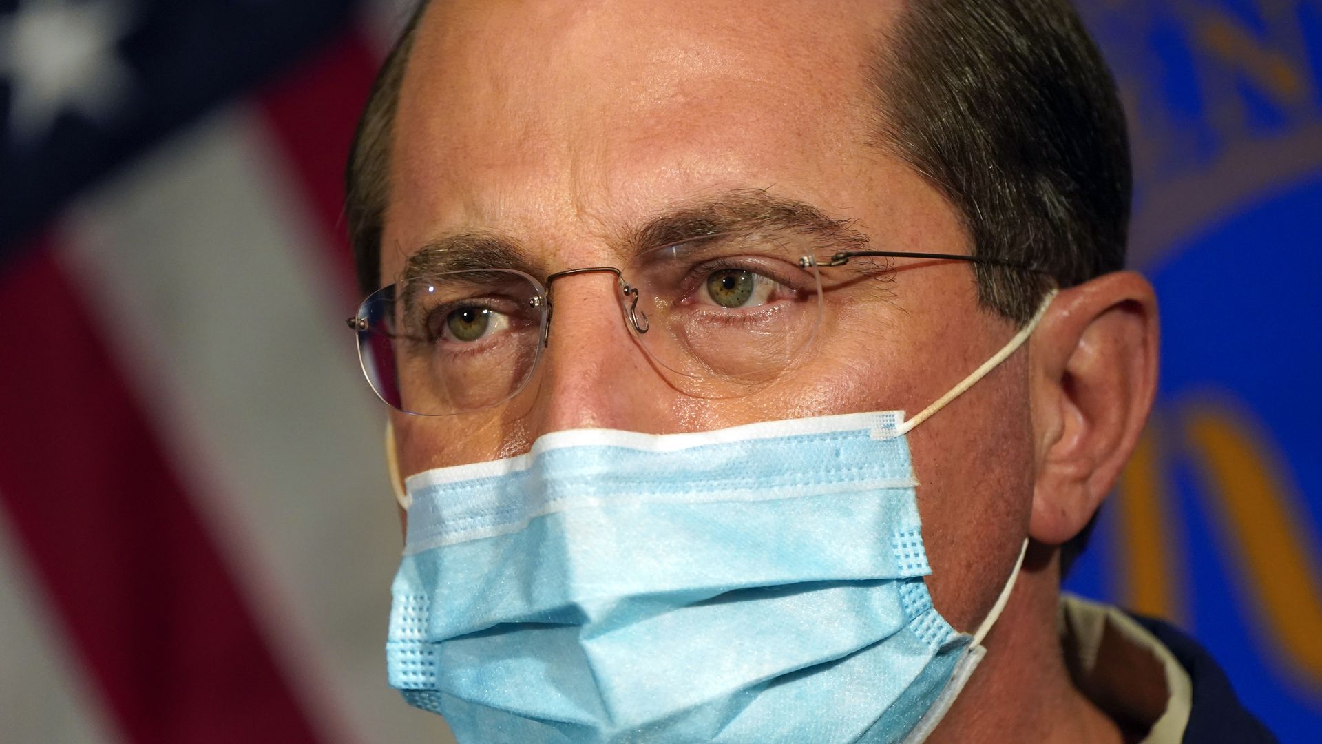 Photo of a masked Alex Azar's face