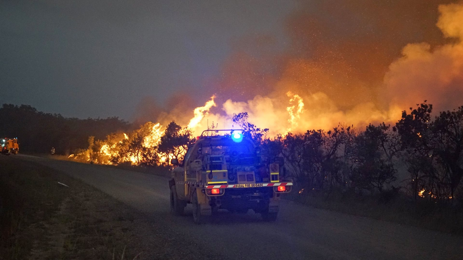 A fire truck races towards a blaze in the Deepwater National Park area of Queensland.