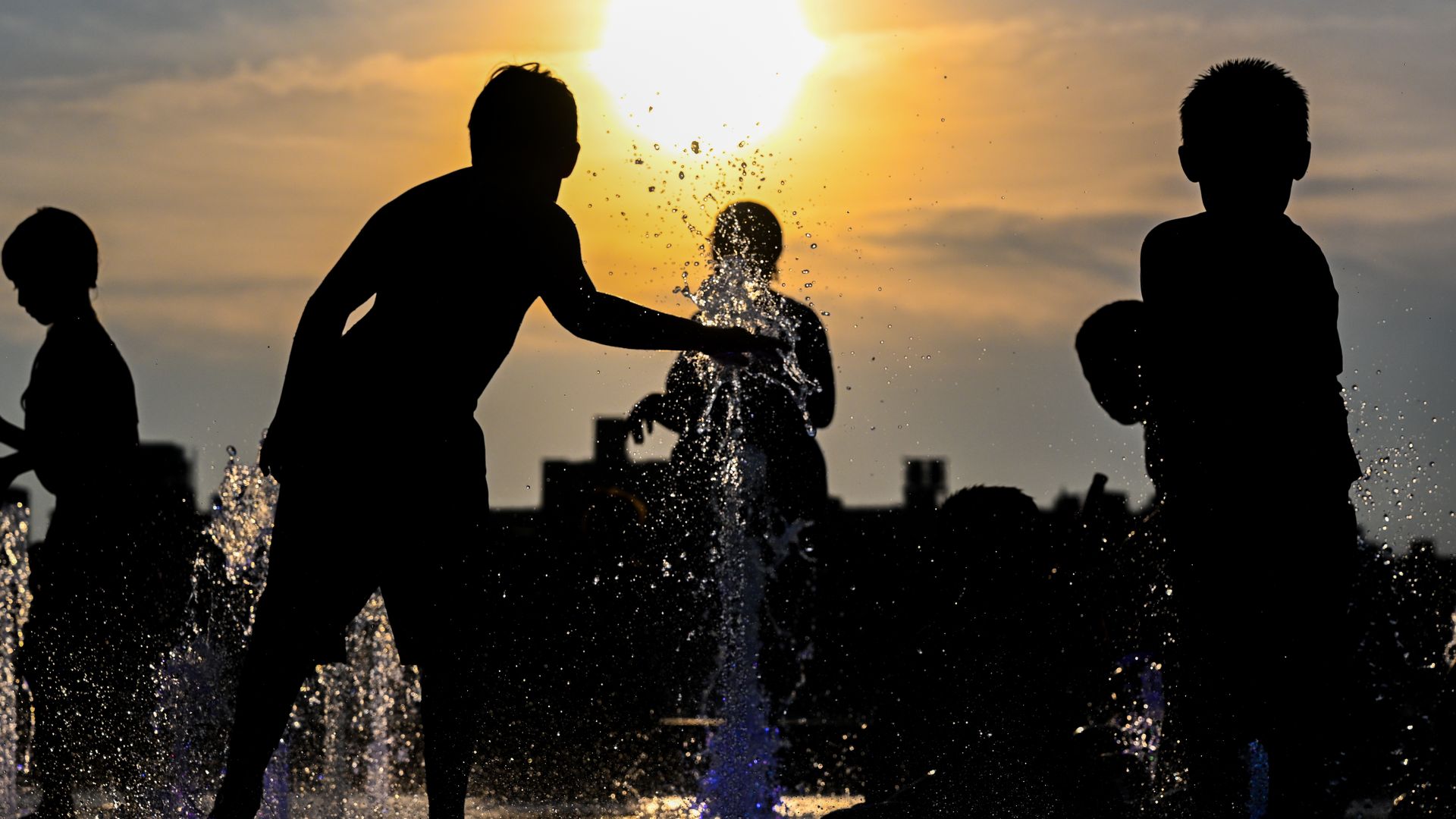 People in a fountain in New York City on July 24.