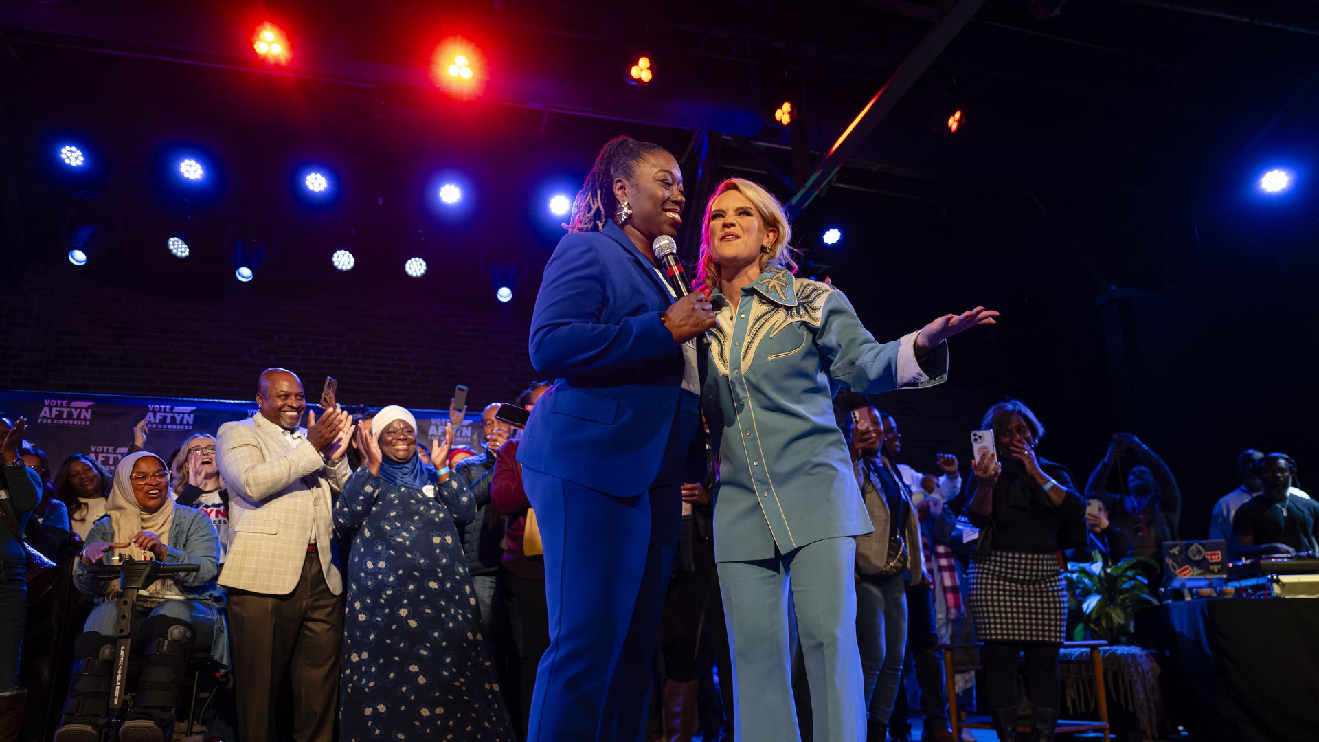 State Rep. Aftyn Behn, right, takes the stage to a cheering crowd prior to her concession speech on Tuesday night.