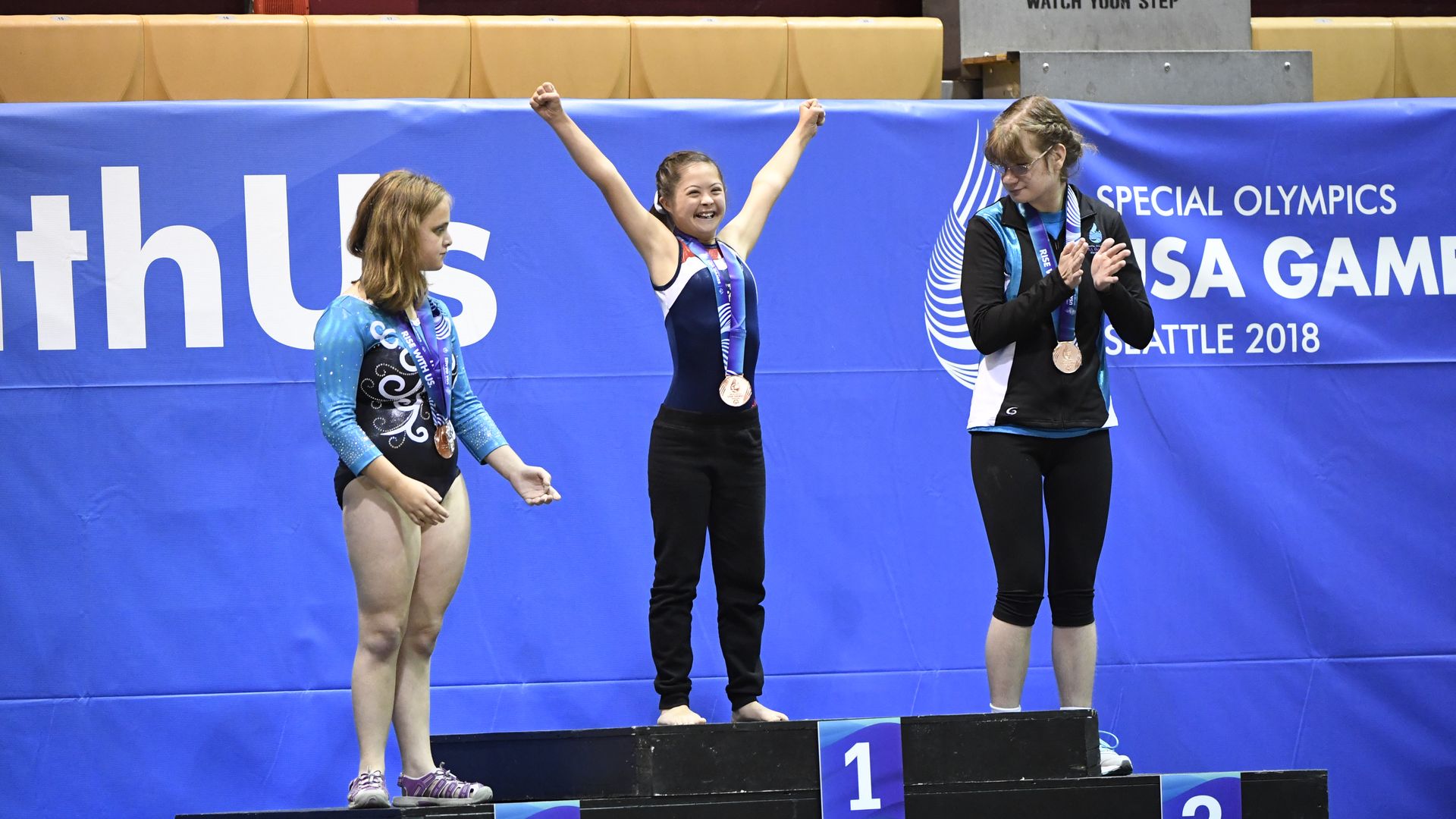 Three gymnasts on podium at special olympics Seattle 2018