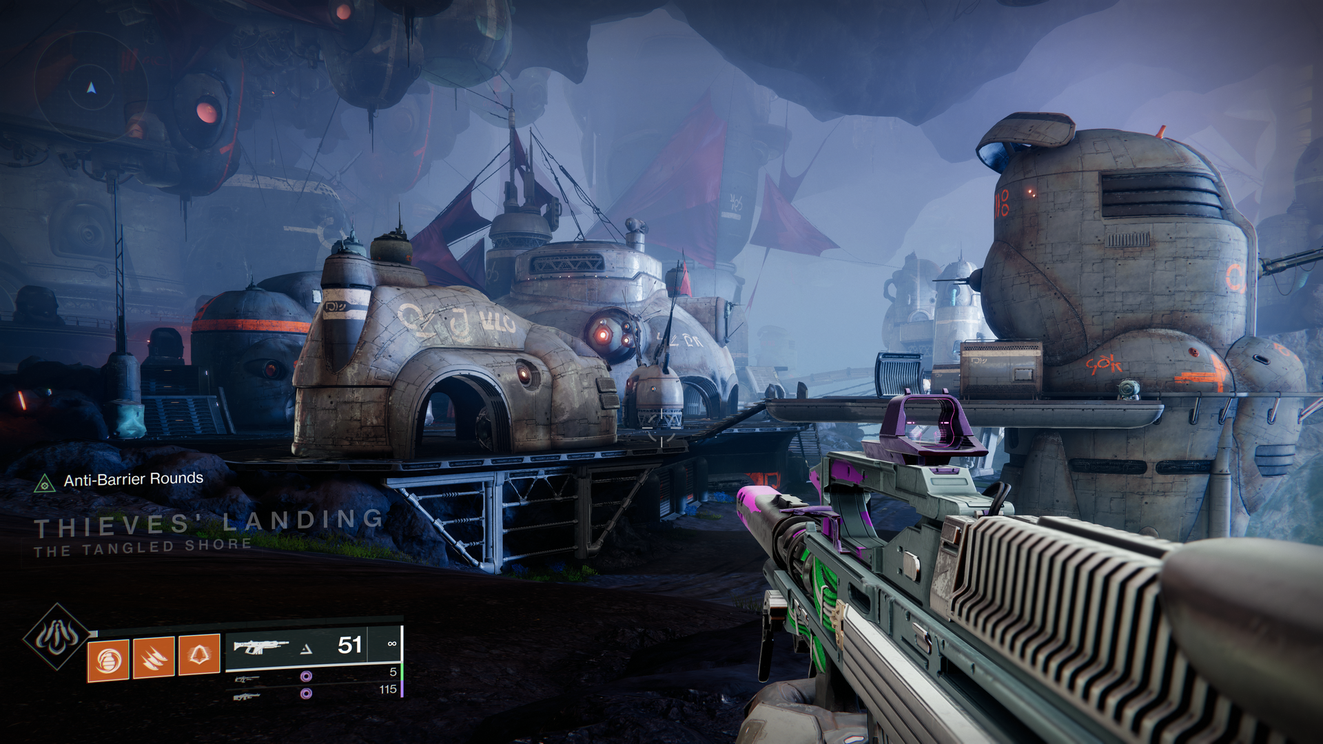 Video game screenshot of an alien city at night time.