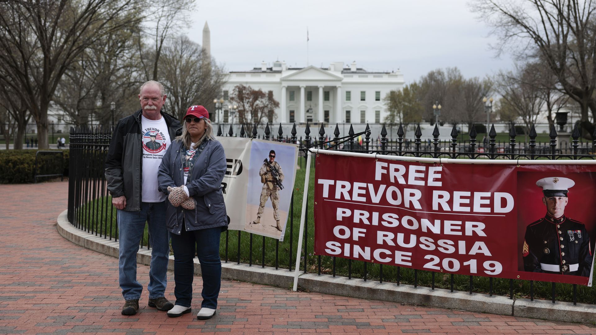 The parents of former hostage Trevor Reed are seen protesting outside the White House.