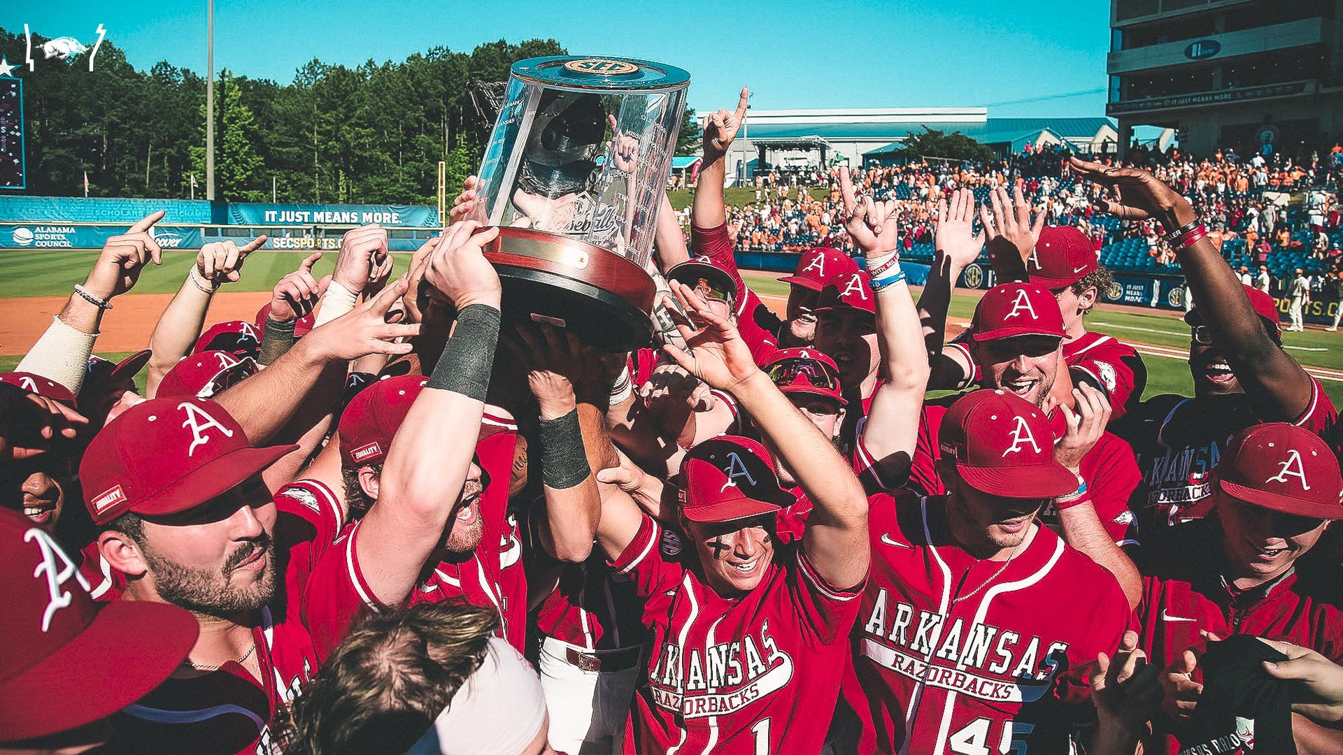 The Arkansas baseball team holds up the SEC championship trophy