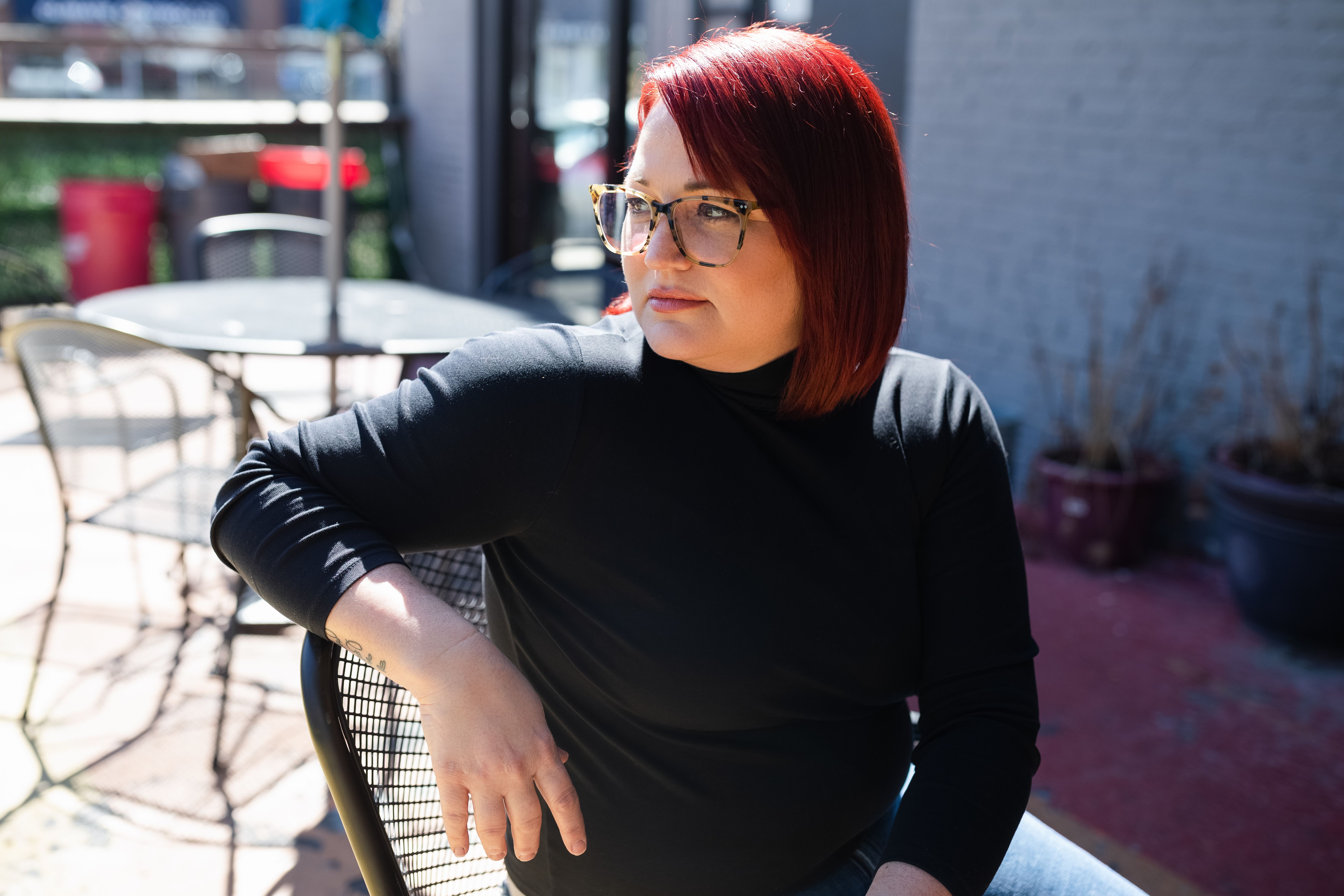 Bobbi Moore sits in a chair on Slammers' patio