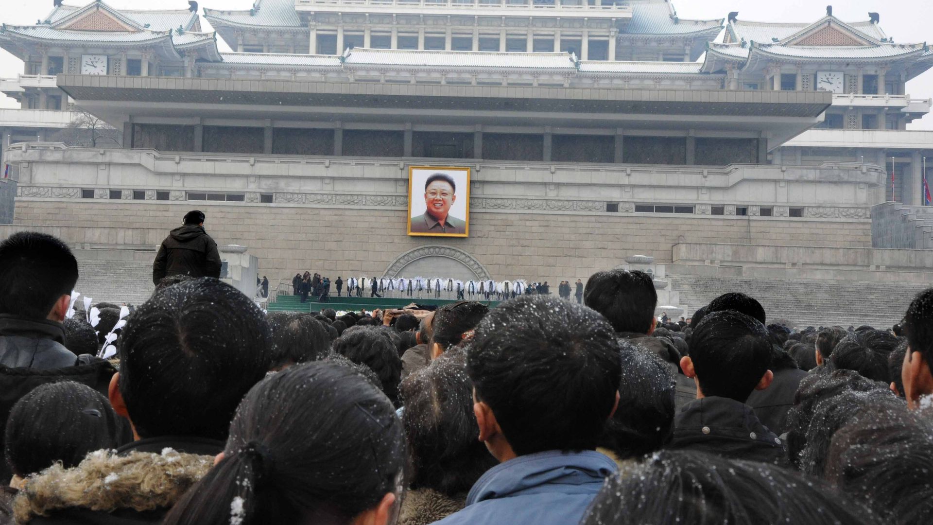 Pyongyang citizens gathering to mourn in front of a portrait of late North Korean leader Kim Jong-il at the Pyongyang Gymnasium. 