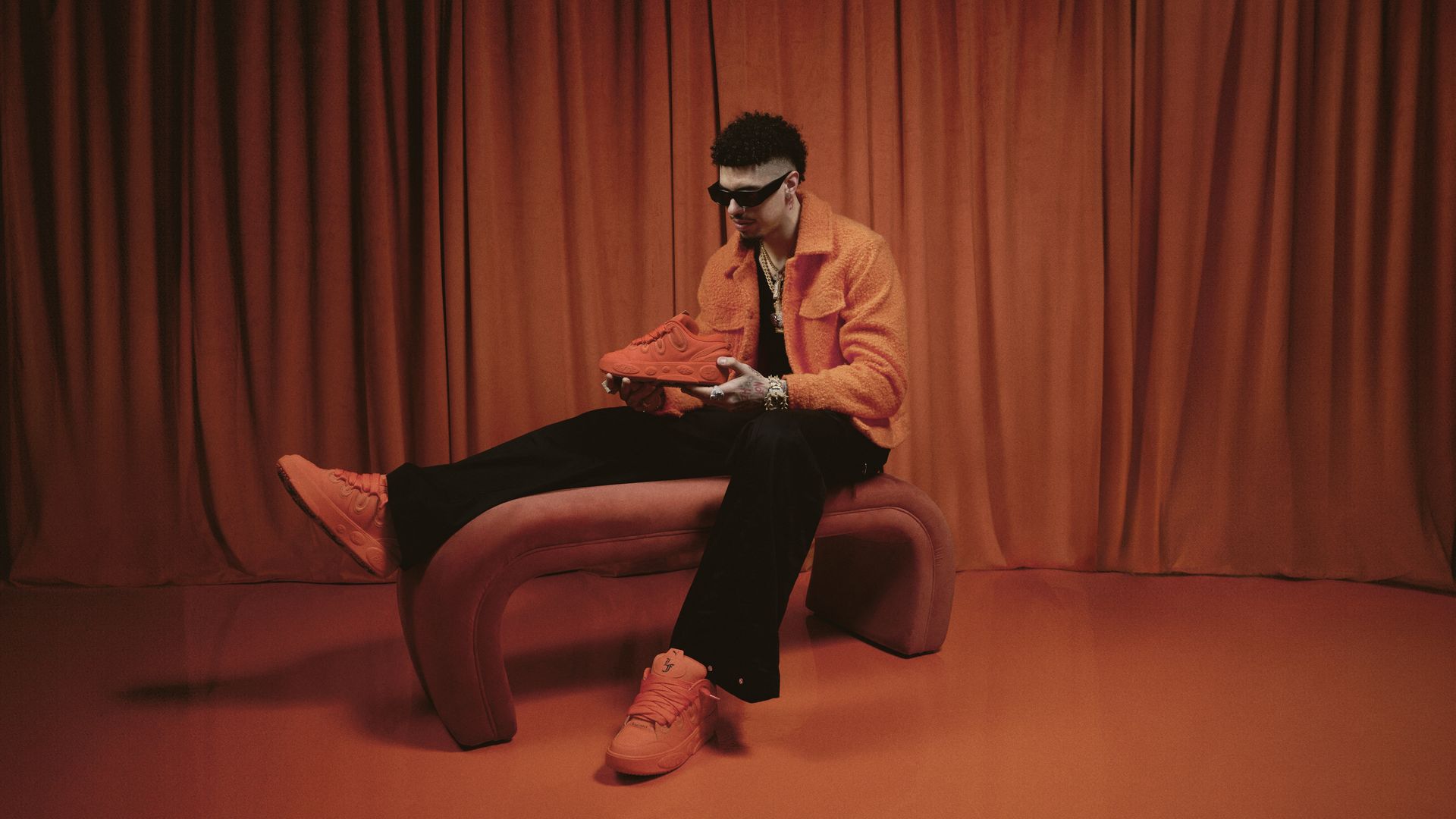 LaMelo Ball holding his new shoe.